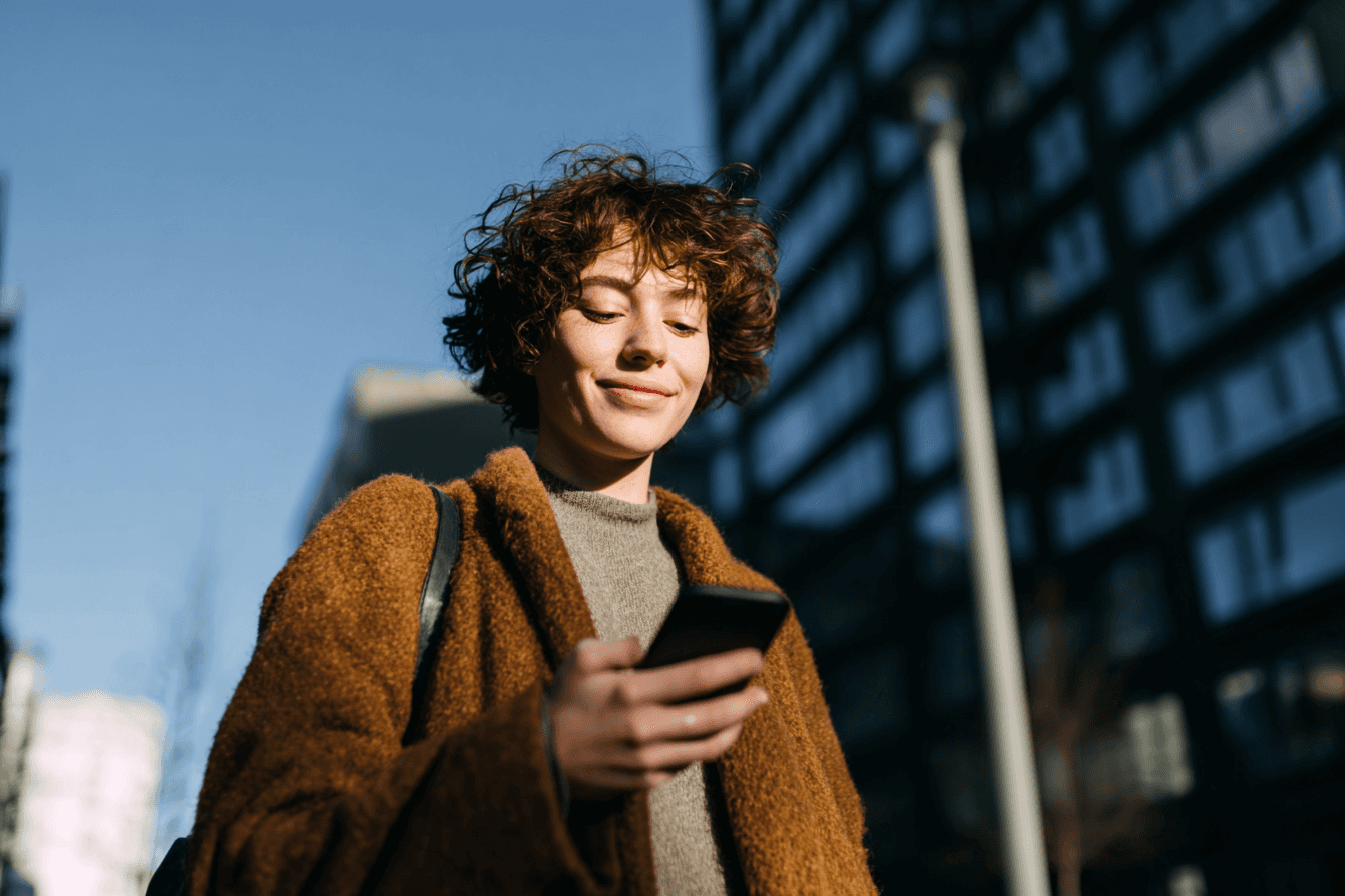 A maroon passport, a credit card, and a document are placed on a dark surface.