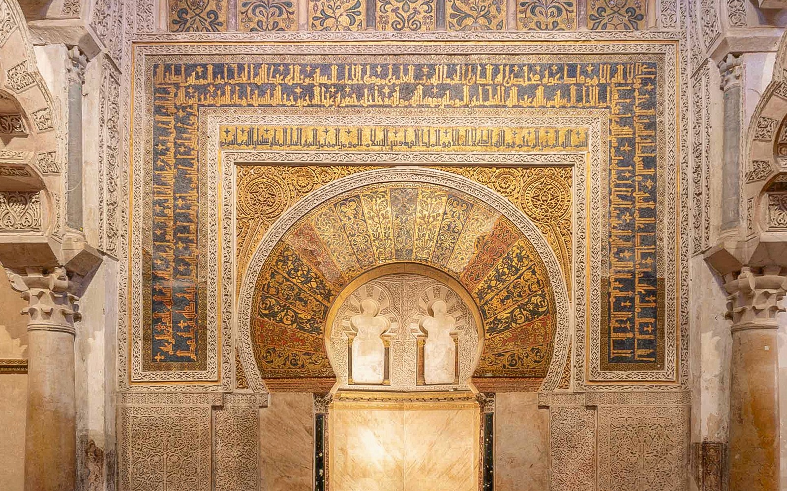 Intricate archway with Arabic calligraphy in Cordoba Mosque, Spain.