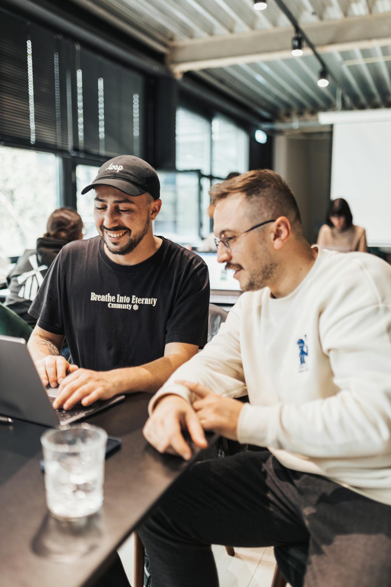 Young Men Looking at the Laptop Screen and Smiling