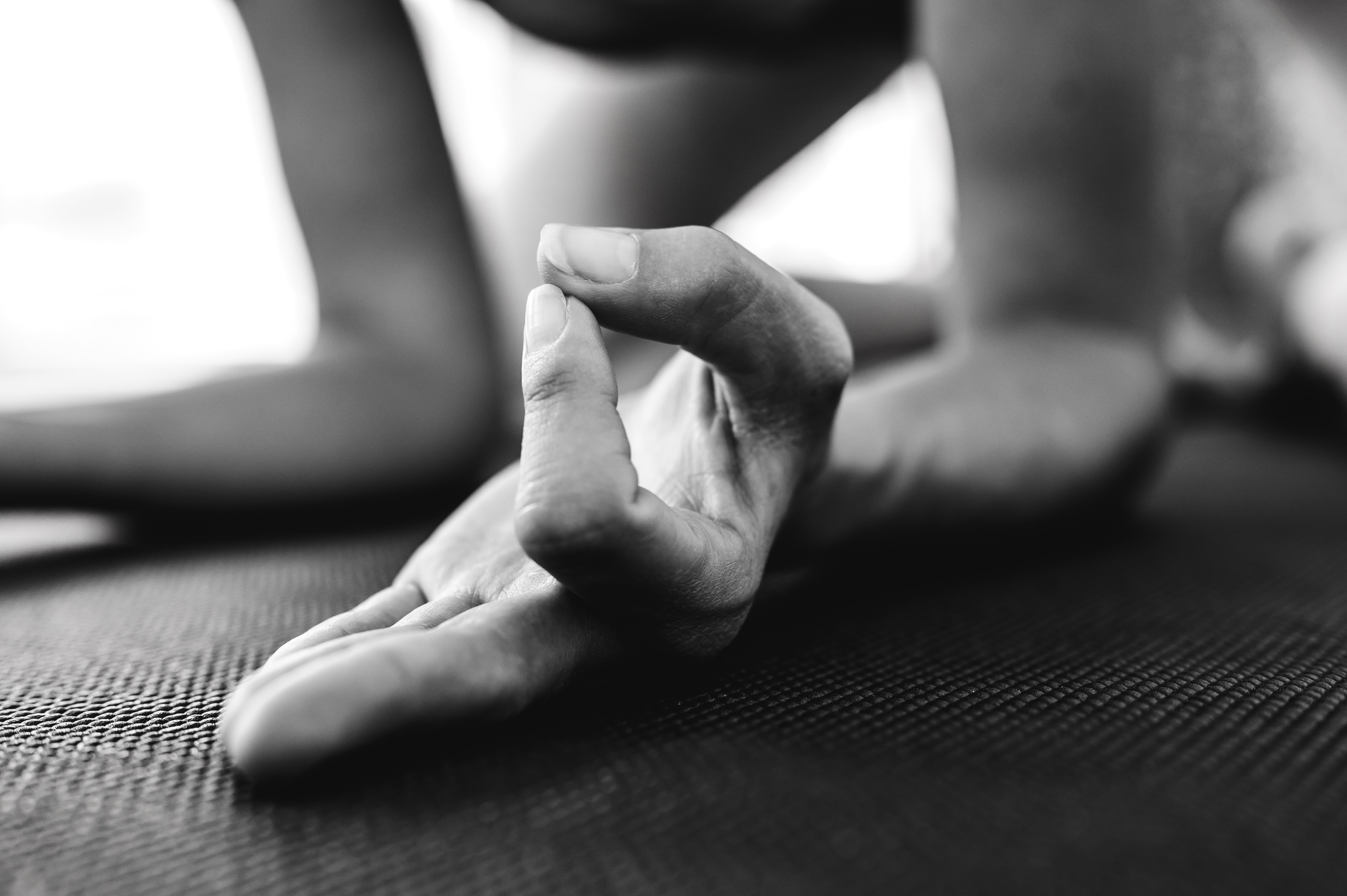 A person standing bare foot on a yoga mat