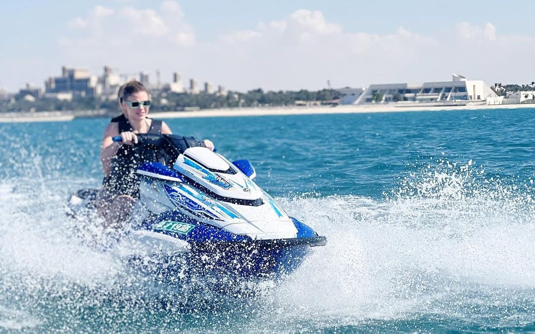 A person riding a jet ski on calm blue waters, highlighting the mental advantages and benefits of jet ski for boosting mental health and relieving stress