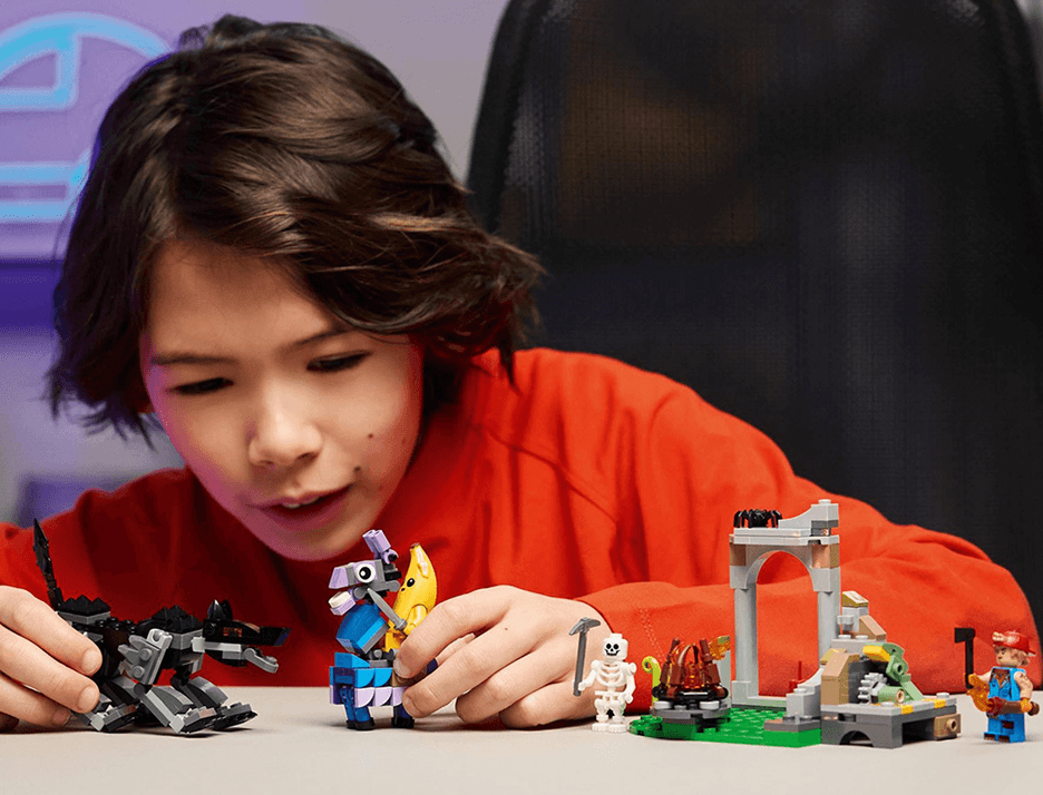 A young boy playing with small figurines