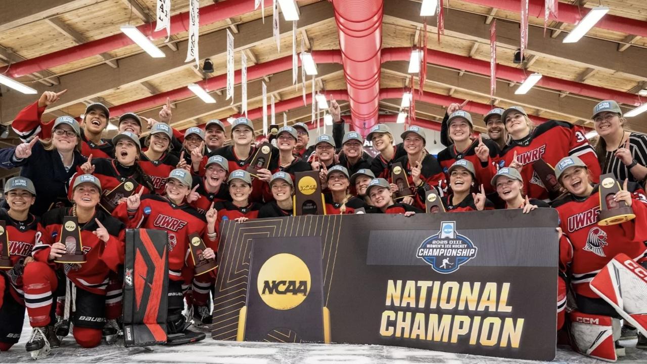 A picture of two boys competing at a wrestling competition.