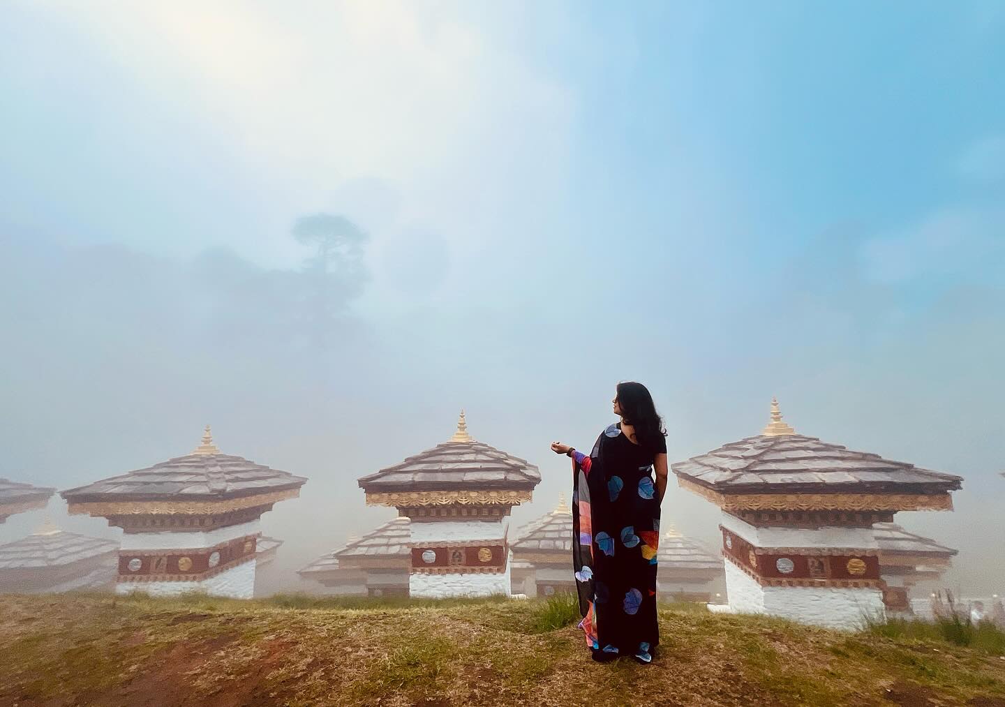 a couple of people standing on top of a mountain