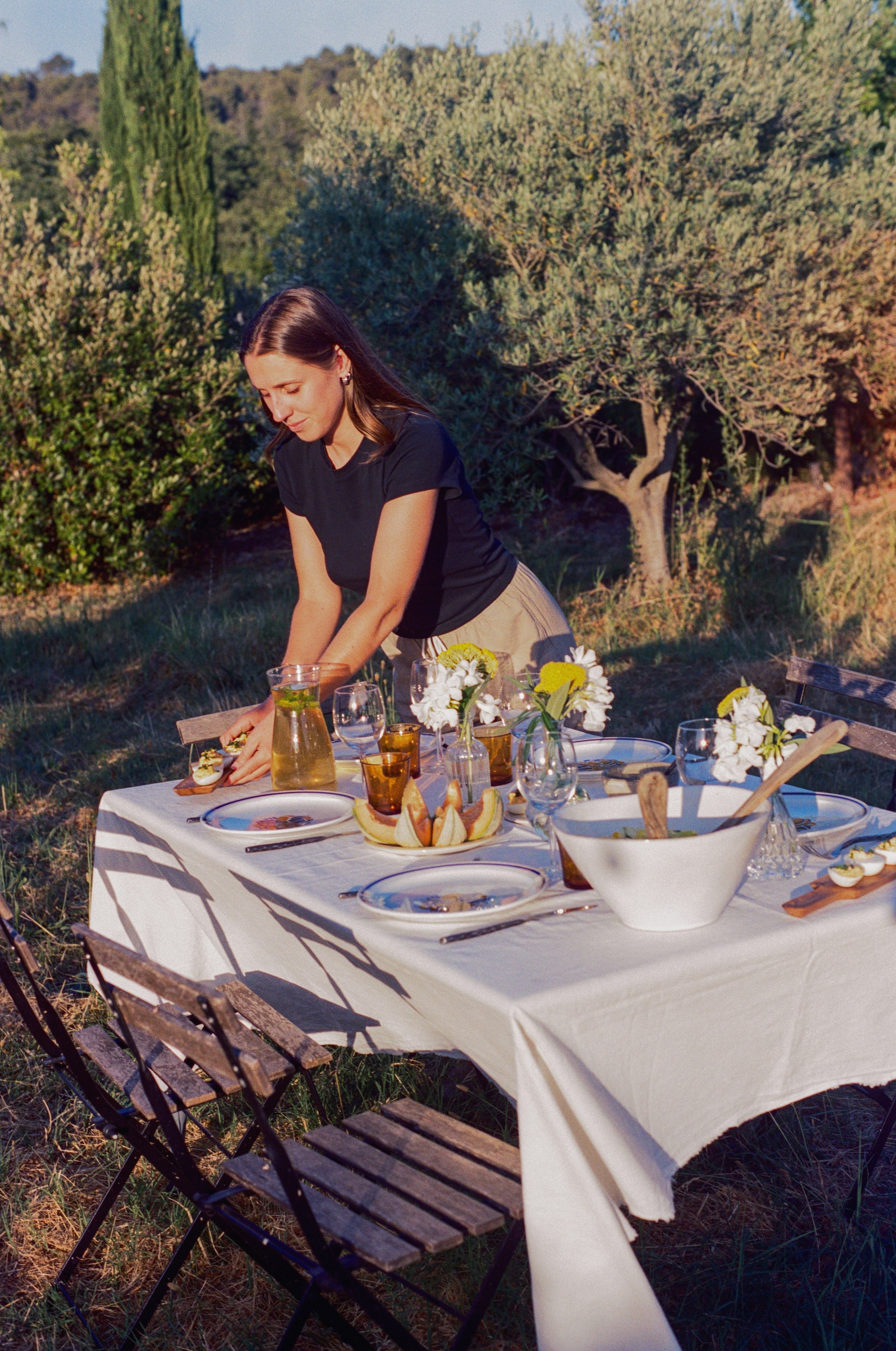 Person pouring oil on zucchini