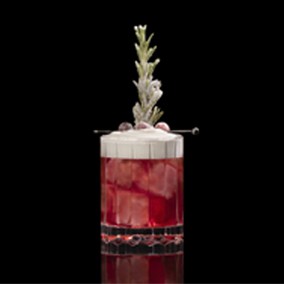 A closeup of a Cranberry Whip drink against a dark background.