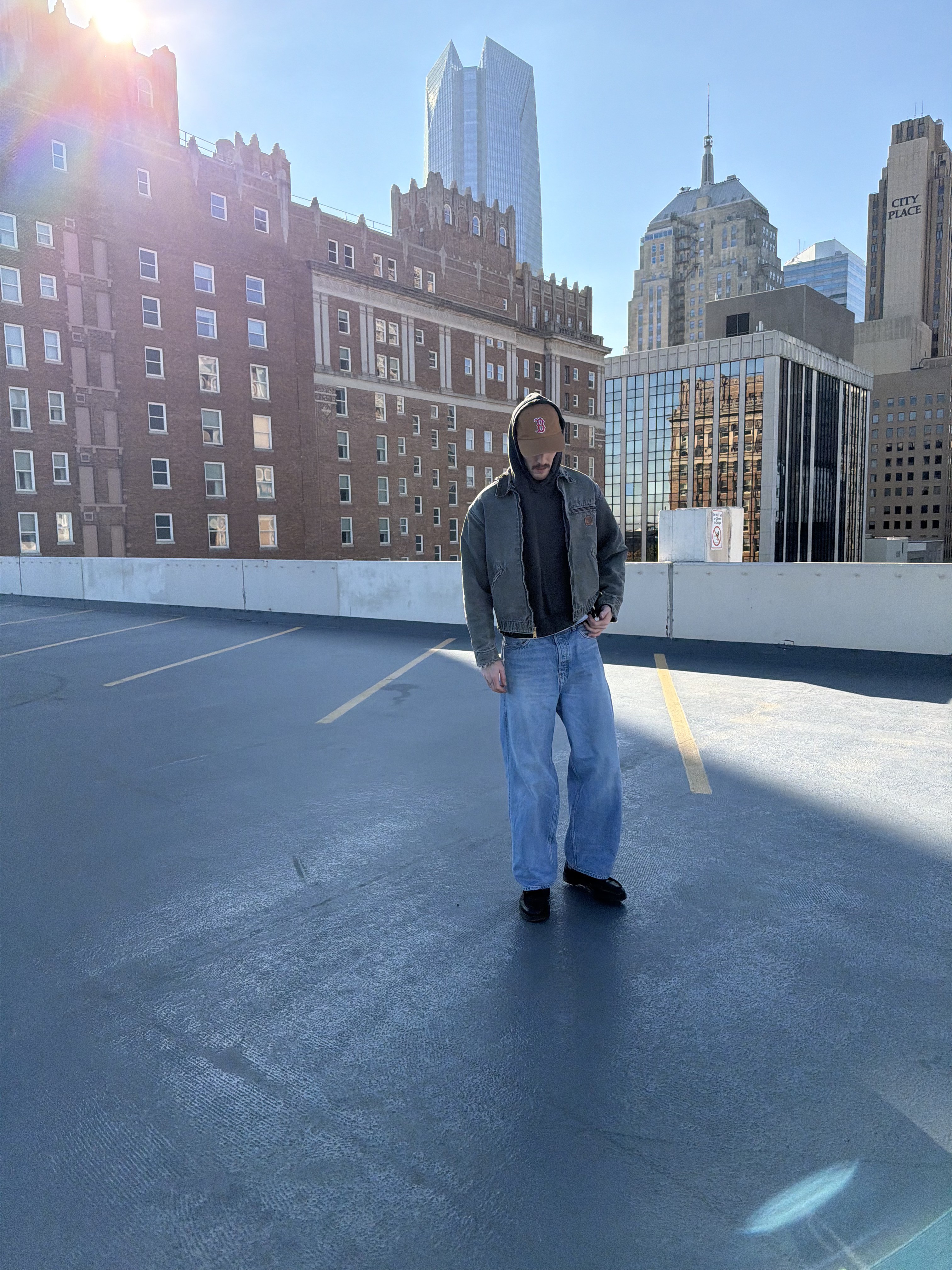 B/W photo: woman with braids (left) and man in suit (right) framed by dark panels.