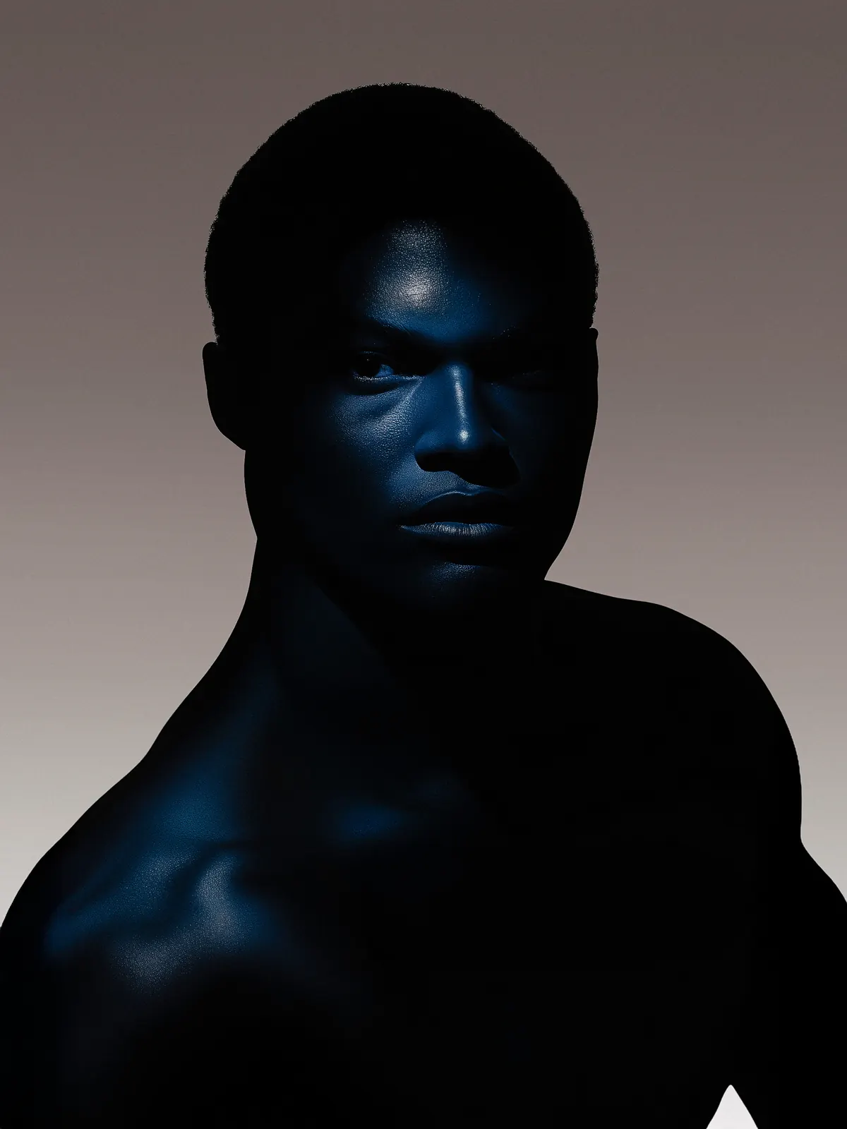 Low-light portrait with short hair and blue highlights against a gray background.