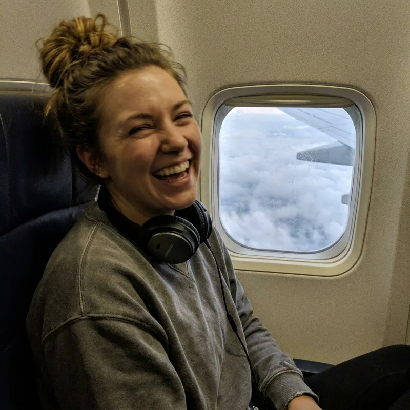 Sarah in a window seat on her flight
