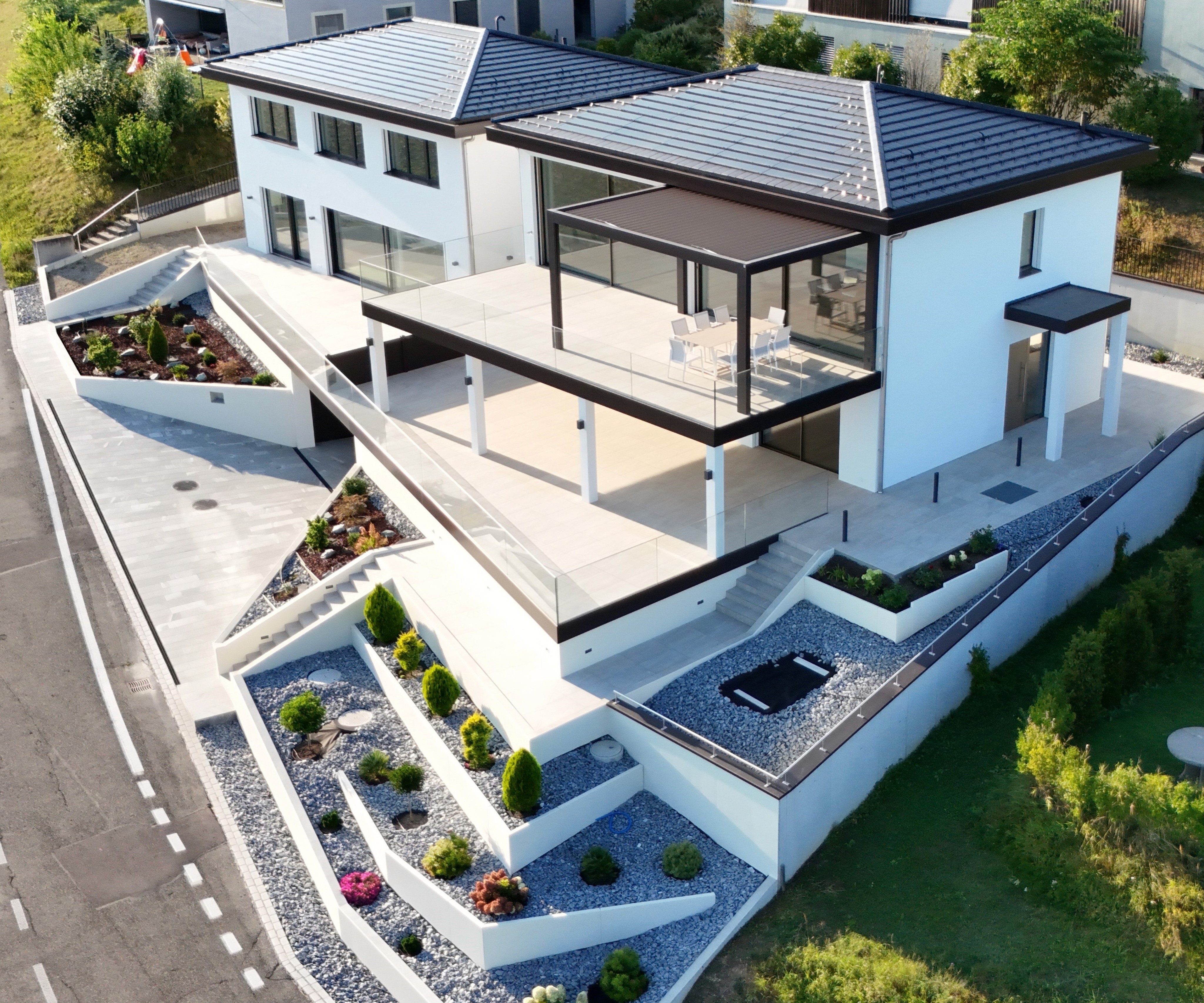 Moderne Einfamilienhäuser in Hanglage mit grosszügiger Terrasse und klarer Architektur