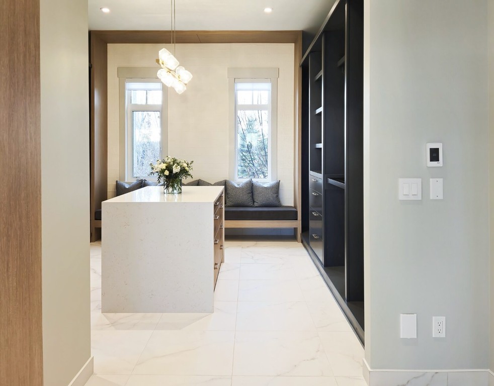 Image of Modern kitchen interior with island, pendant light, and built-in seating area designed by KHD Homes.