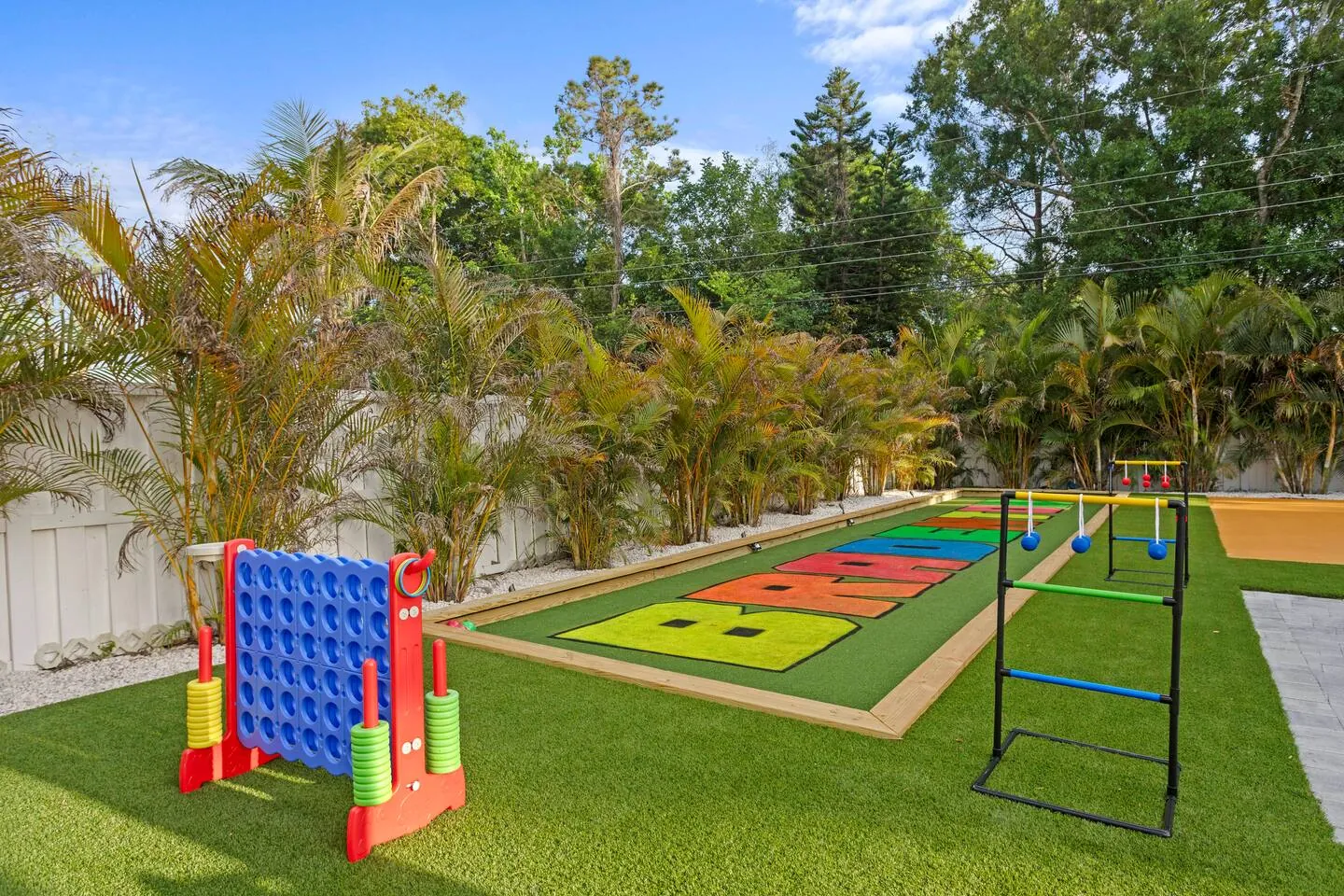 Giant Connect Four with ladder toss and painted turf game court at Private Backyard Resort, Bradenton, Florida