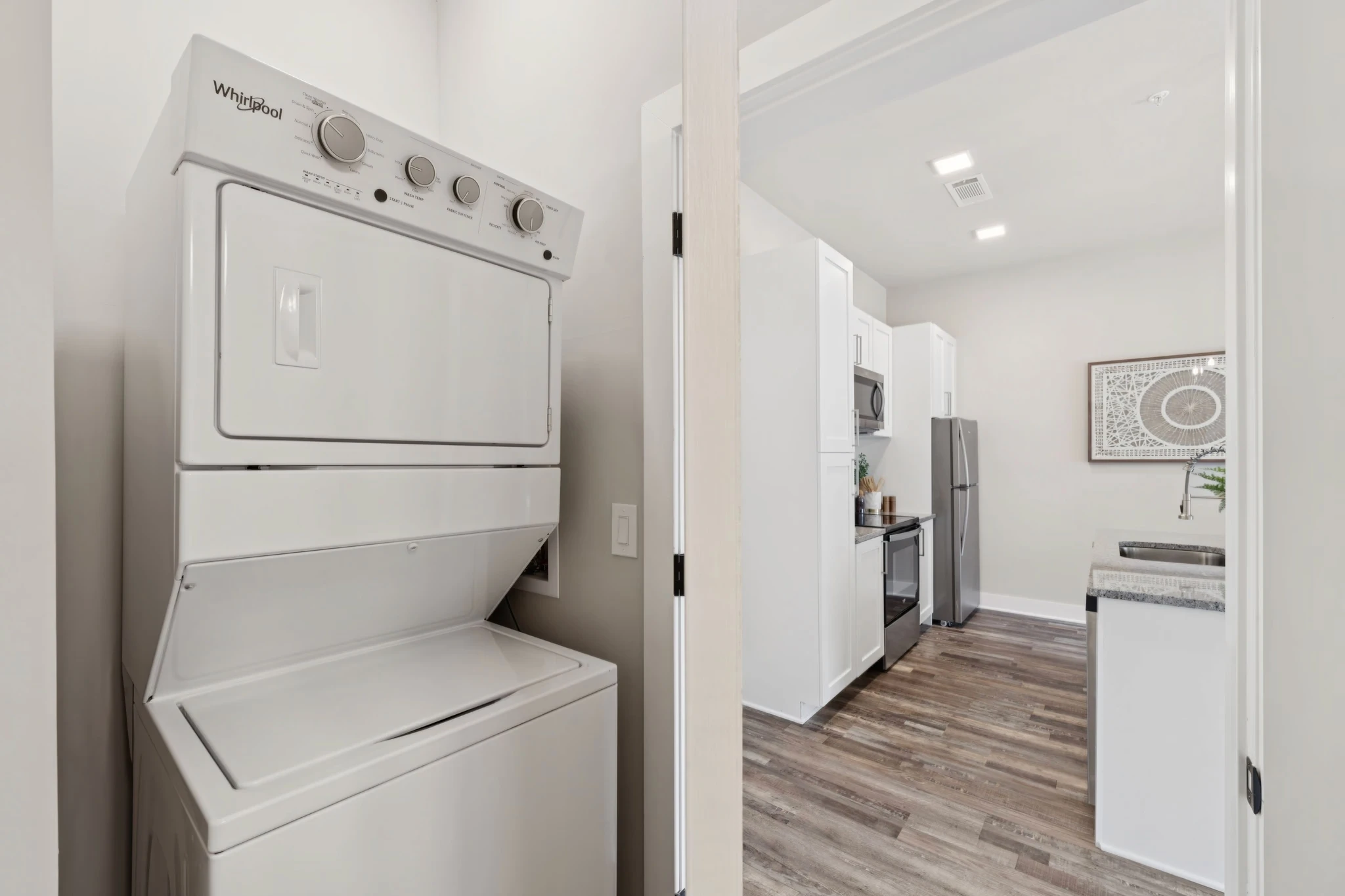 A kitchen featuring a washer and dryer, showcasing a blend of cooking and laundry facilities in one space.