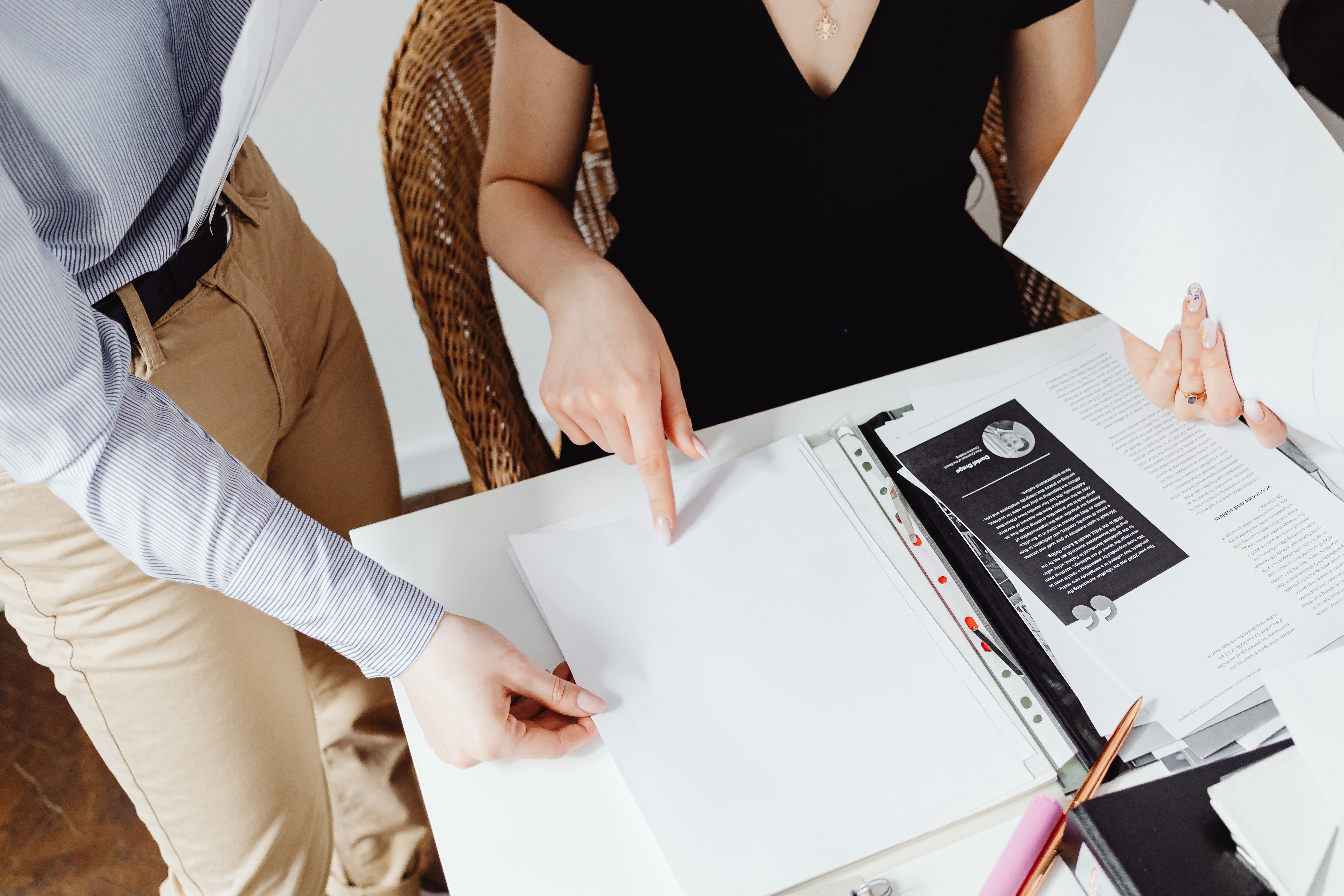 Two colleagues reviewing printed documents together