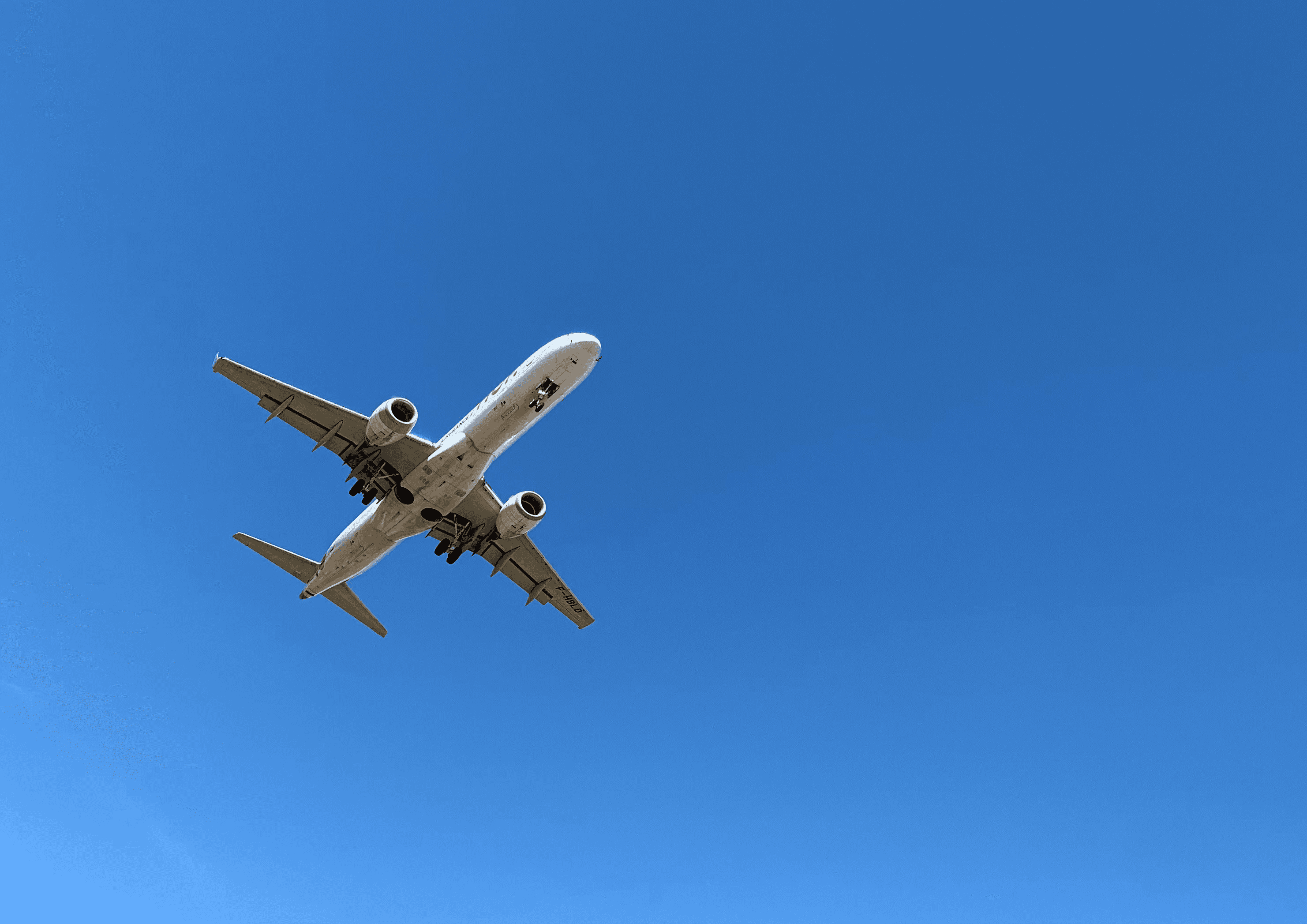 a large jetliner flying through a blue sky