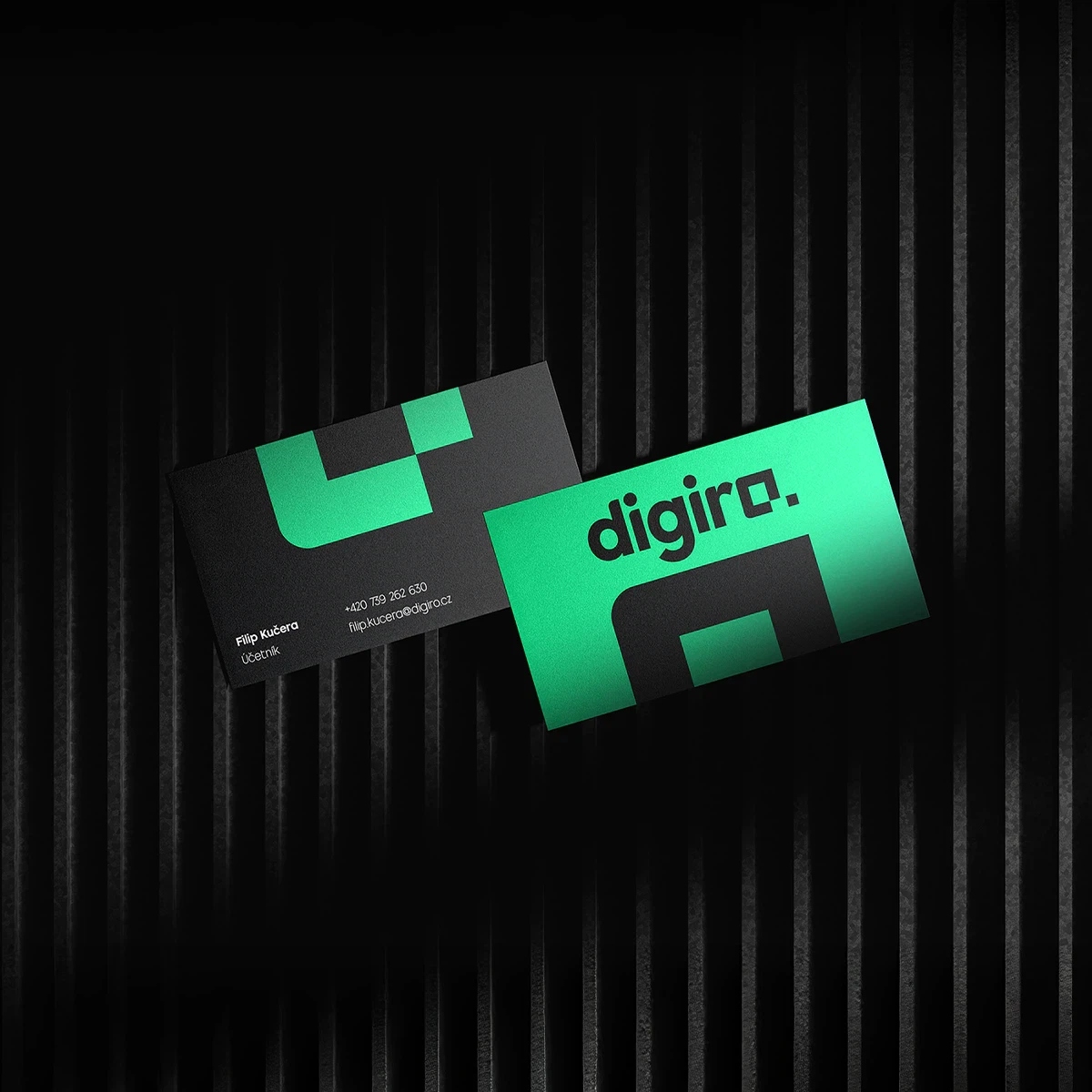 A pair of modern Digiro business cards in black and neon green, displayed on a dark striped background.