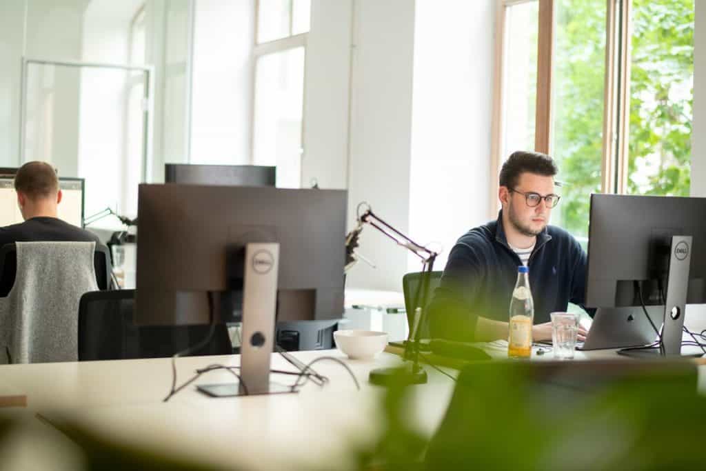 A man in an office setting up multi-channel inventory management.