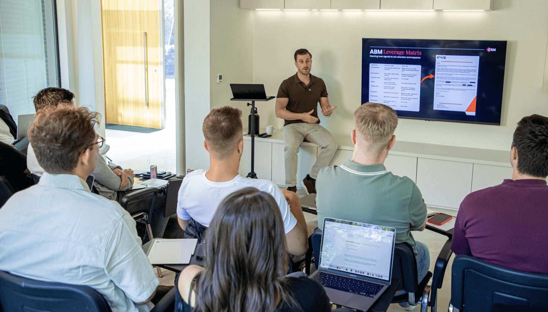 Consultant presenting to a group in a workshop setting, representing a business management consultant guiding leadership teams on strategy and execution.