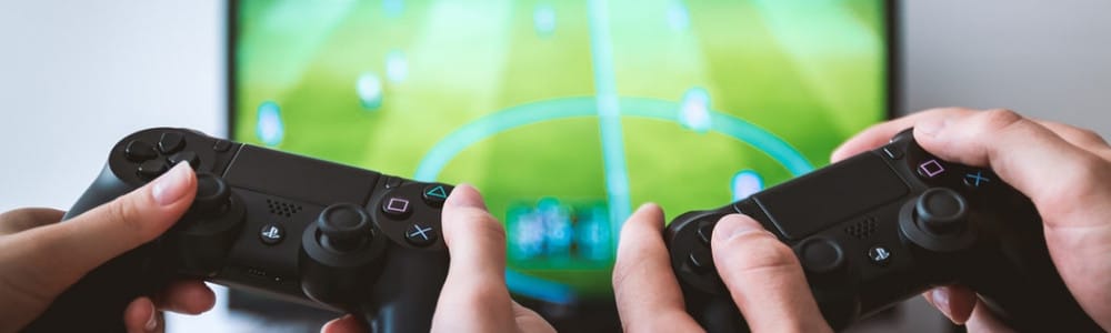 two people playing Sony PS4 game console