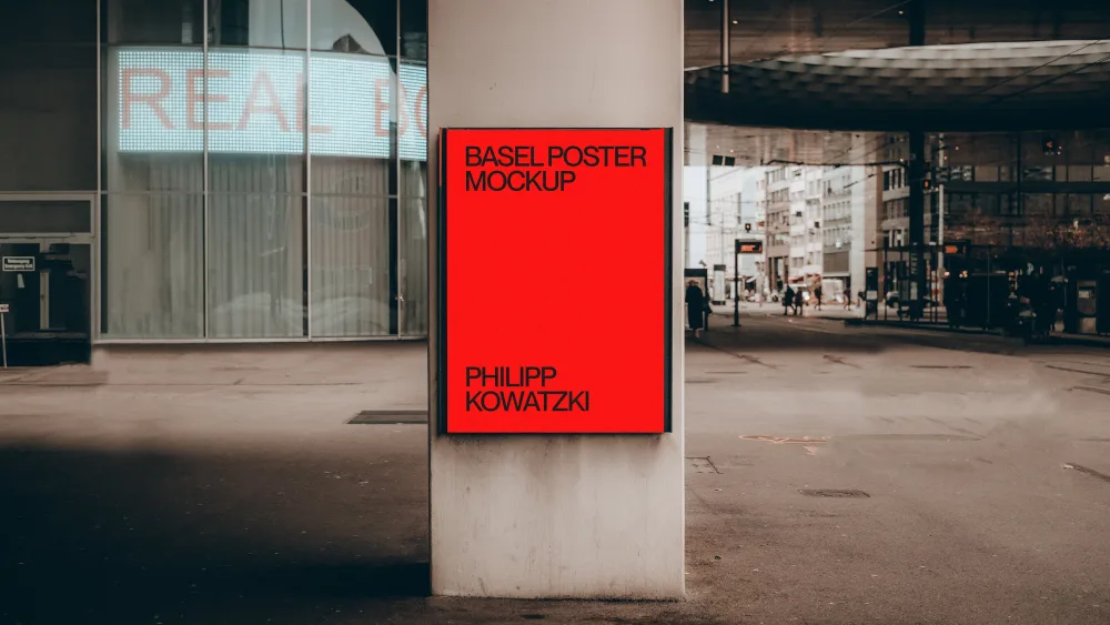 Basel poster mockup displayed on a concrete column in an urban setting. The background features modern architecture, glass reflections, and a busy street with pedestrians and traffic.