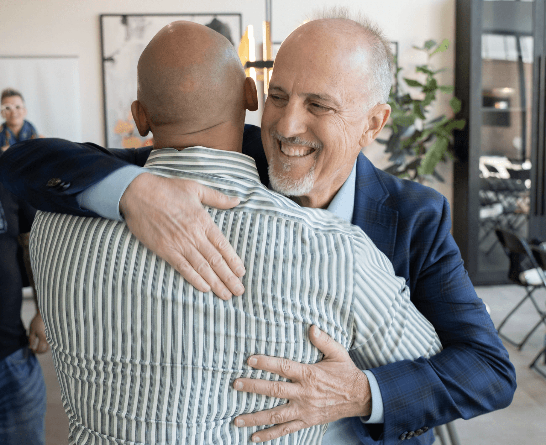 Black and white portrait of a smiling person with curly hair