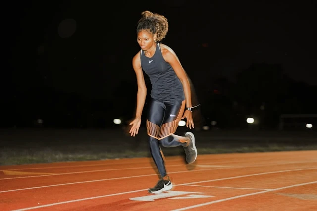 Woman training alone outdoors, focused on movement and balance