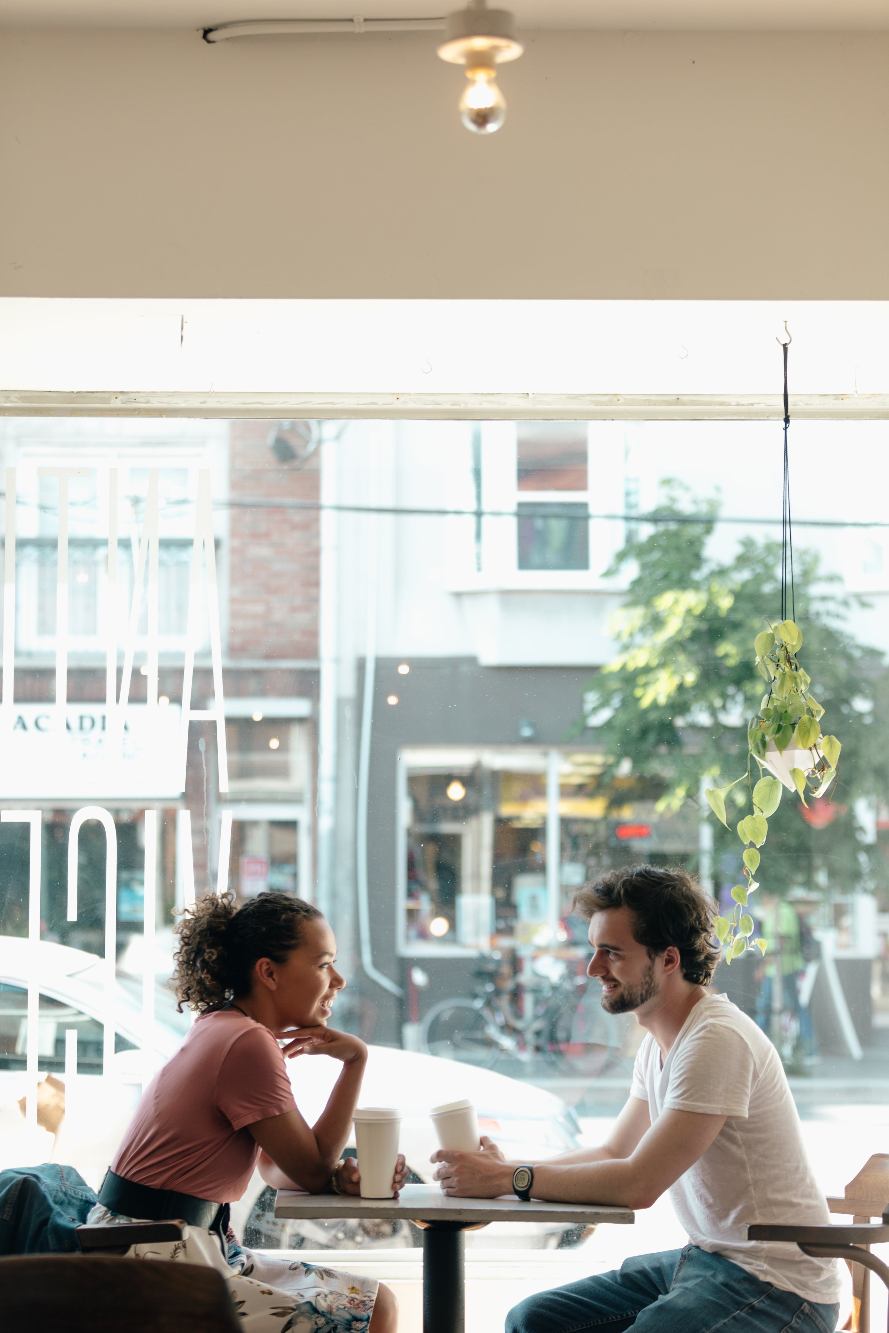 man and a woman are-framed-against a sunny window
