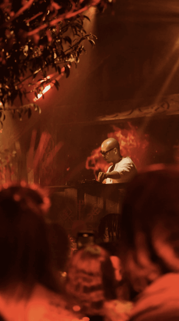 Dancer in black outfit with one leg raised behind