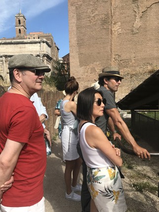 A photo of a group of people visiting some ancient ruins in Rome.
