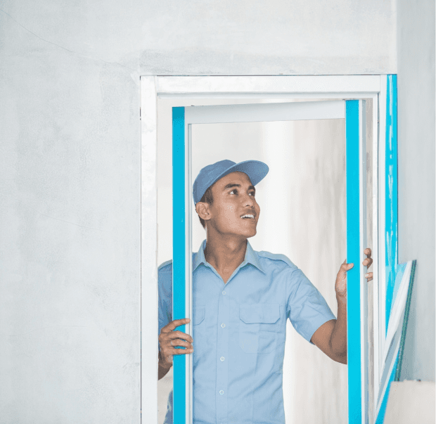 Technician inspecting a window frame.