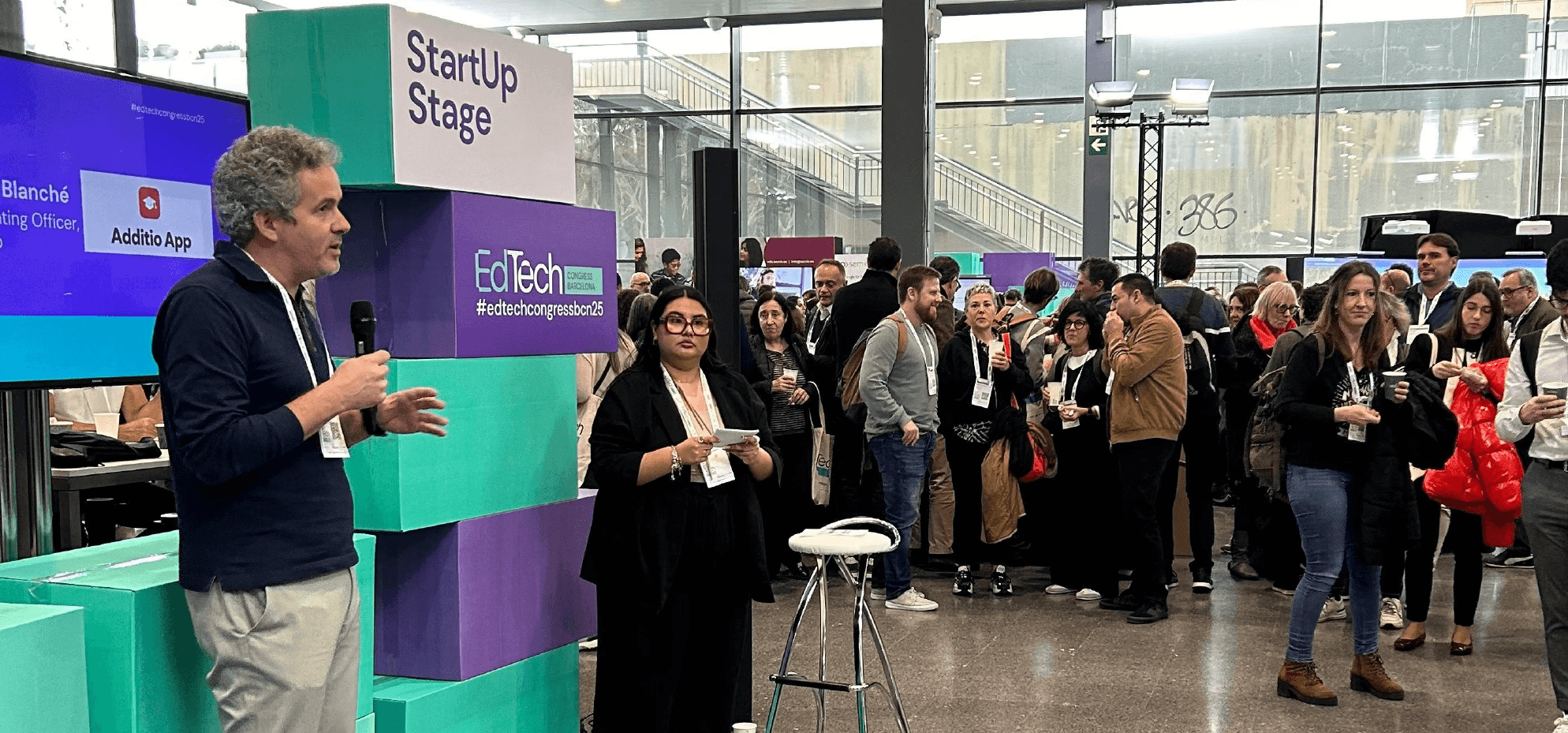 Man presenting on stage at the edtech congress