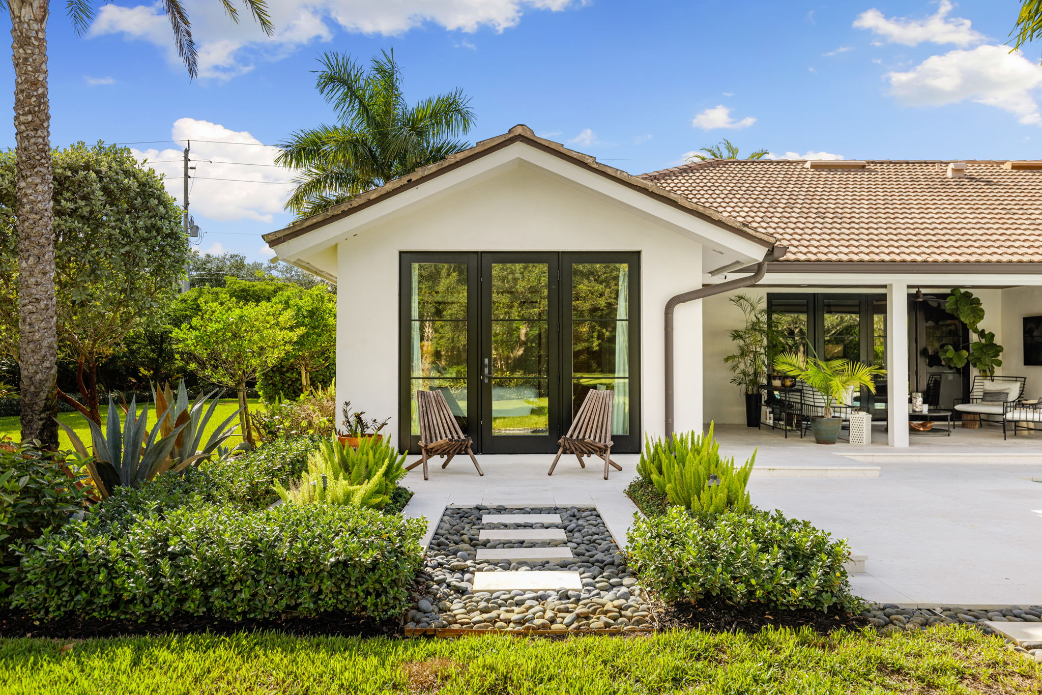 a path into a home with pavers and loose stones