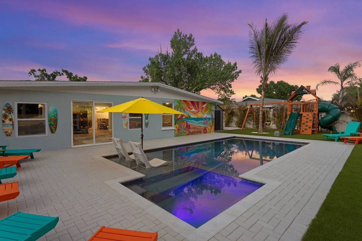 Pool and loungers at twilight at Private Backyard Resort, Bradenton, Florida