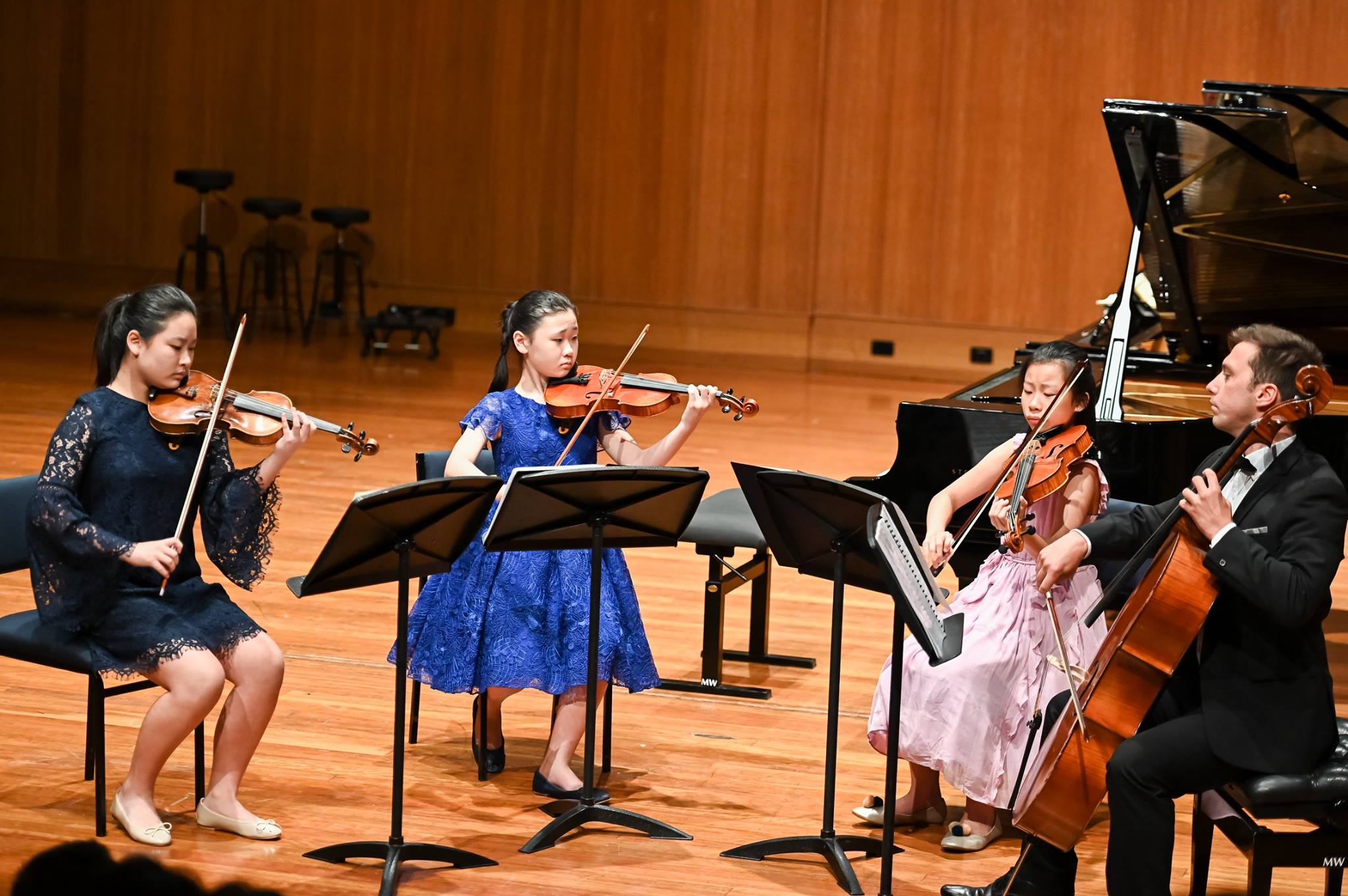 Minimalist abstract image of a stylized turquoise hand gesture on a dark background