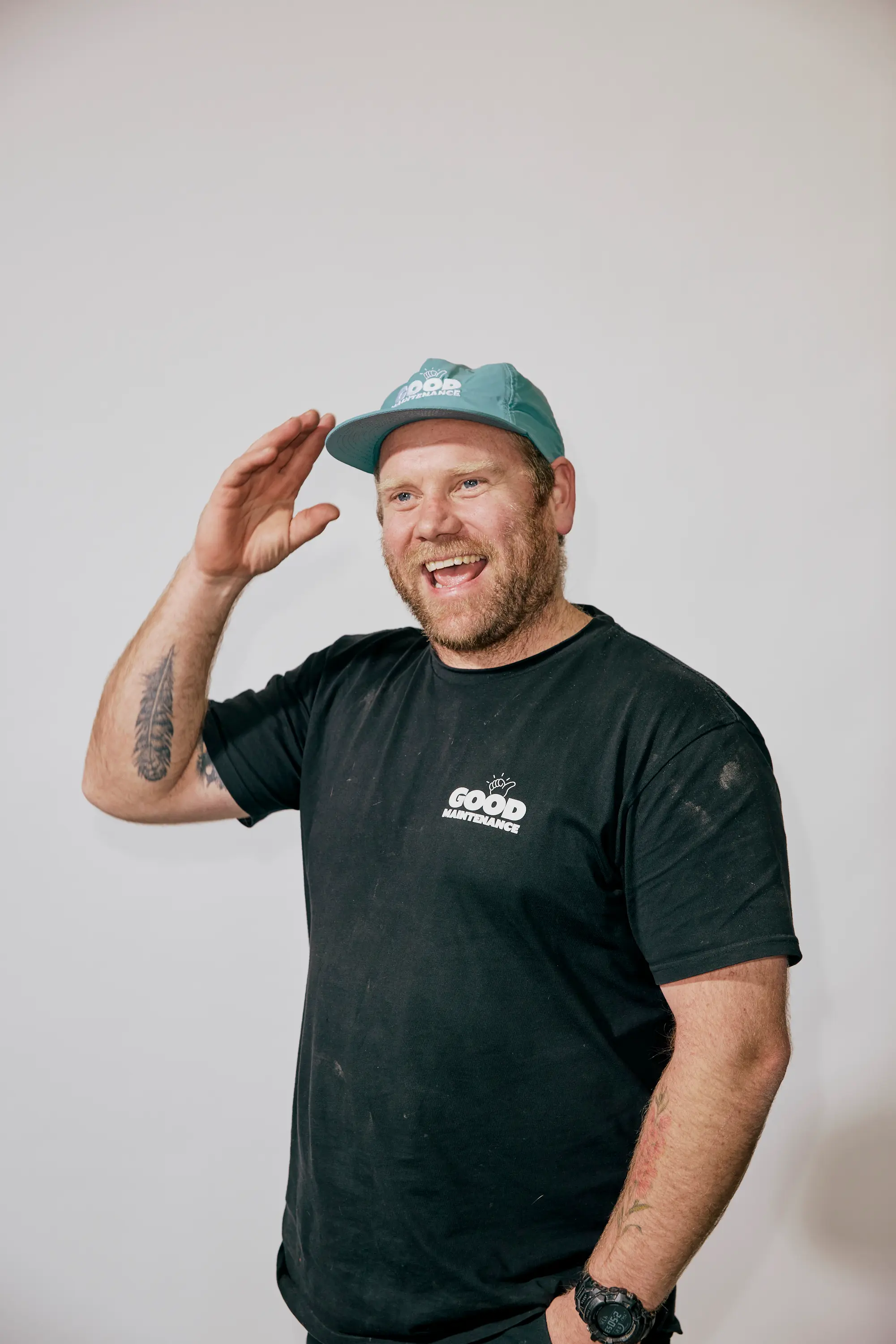 Playful portrait of a male Team Member in Good Maintenance shirt and cap.