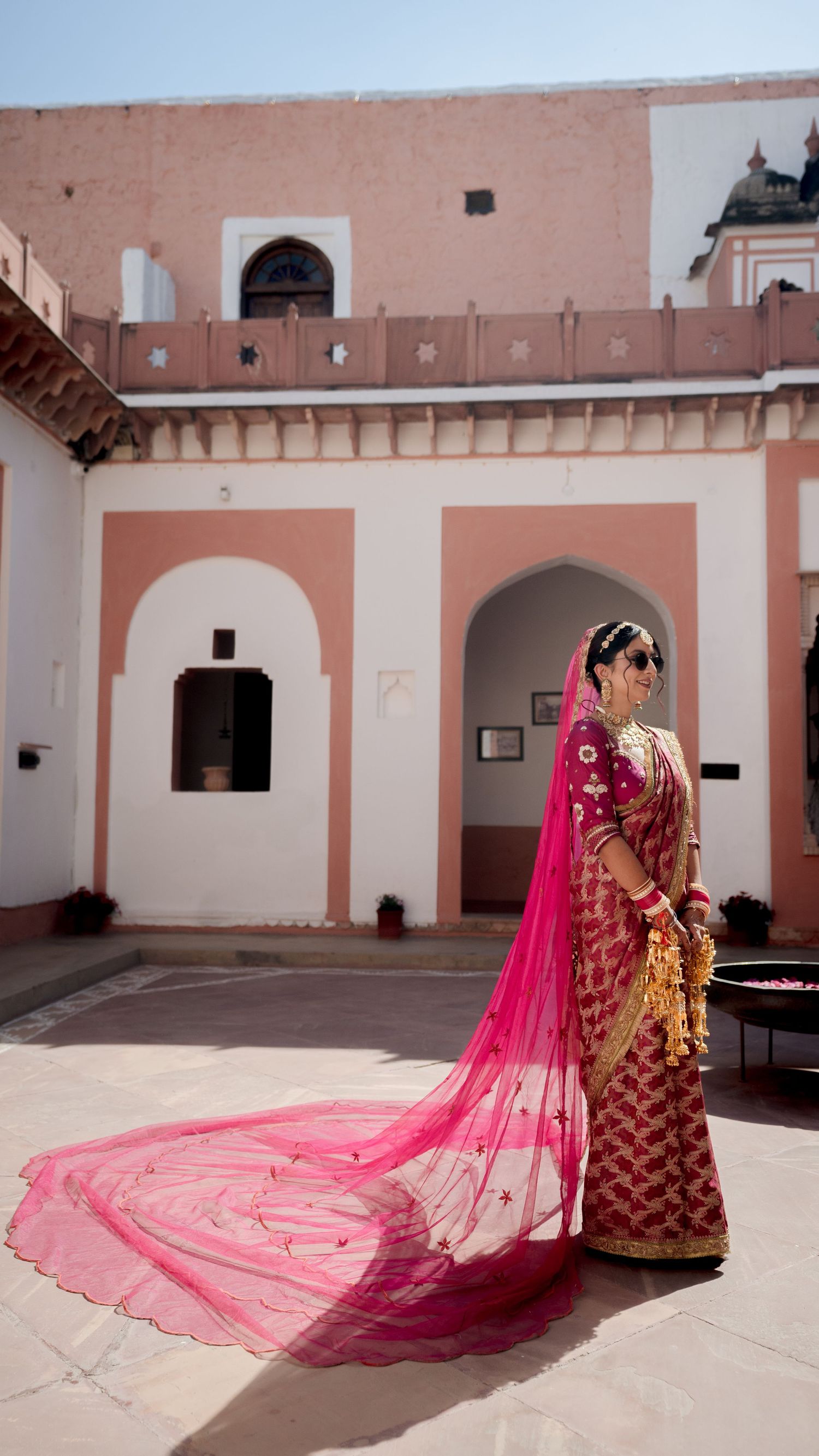 indian bride pink lehenga palace courtyard wedding photography luxury bridal portrait