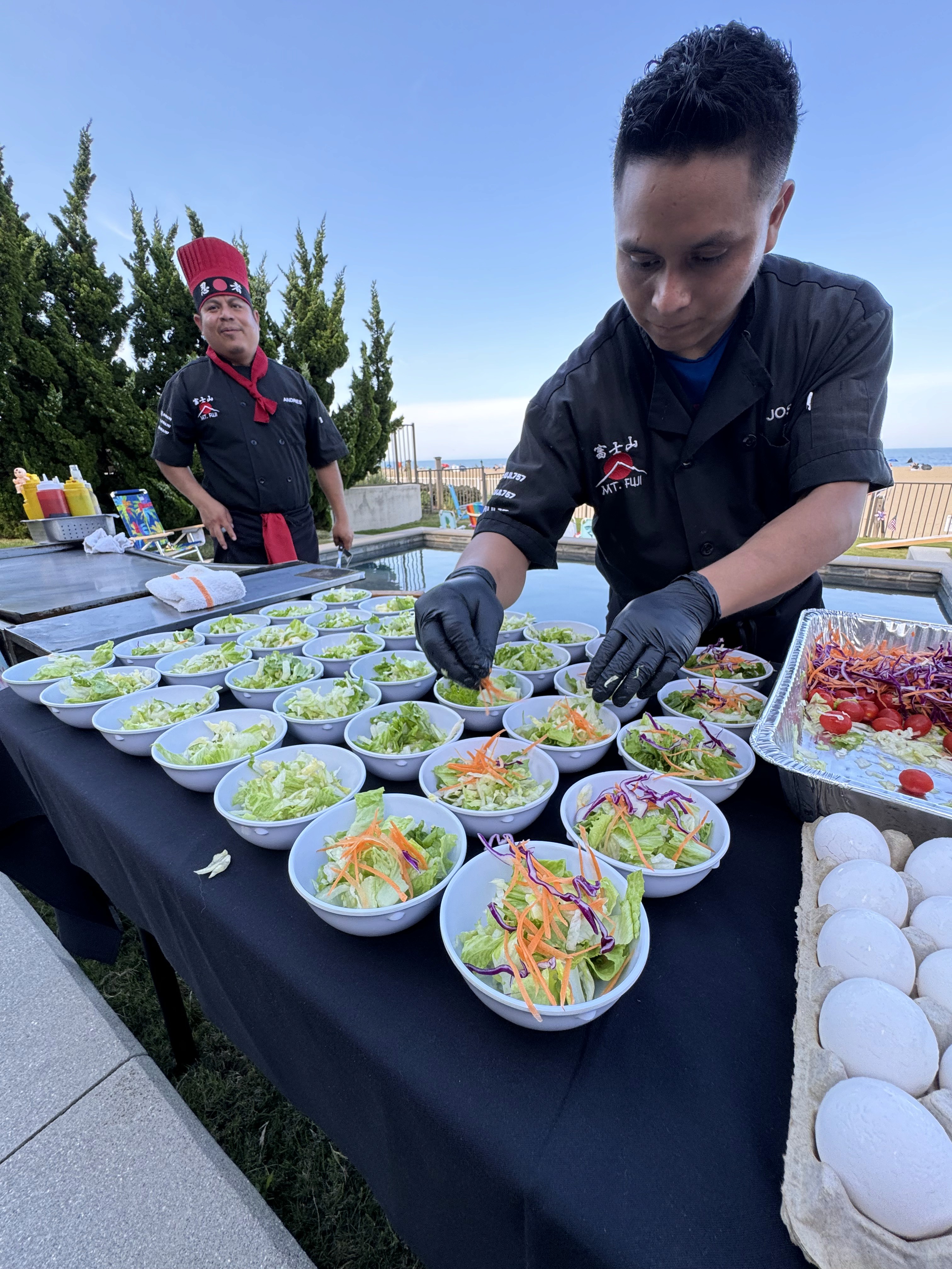chef tossing shrimp on teppanyaki grill