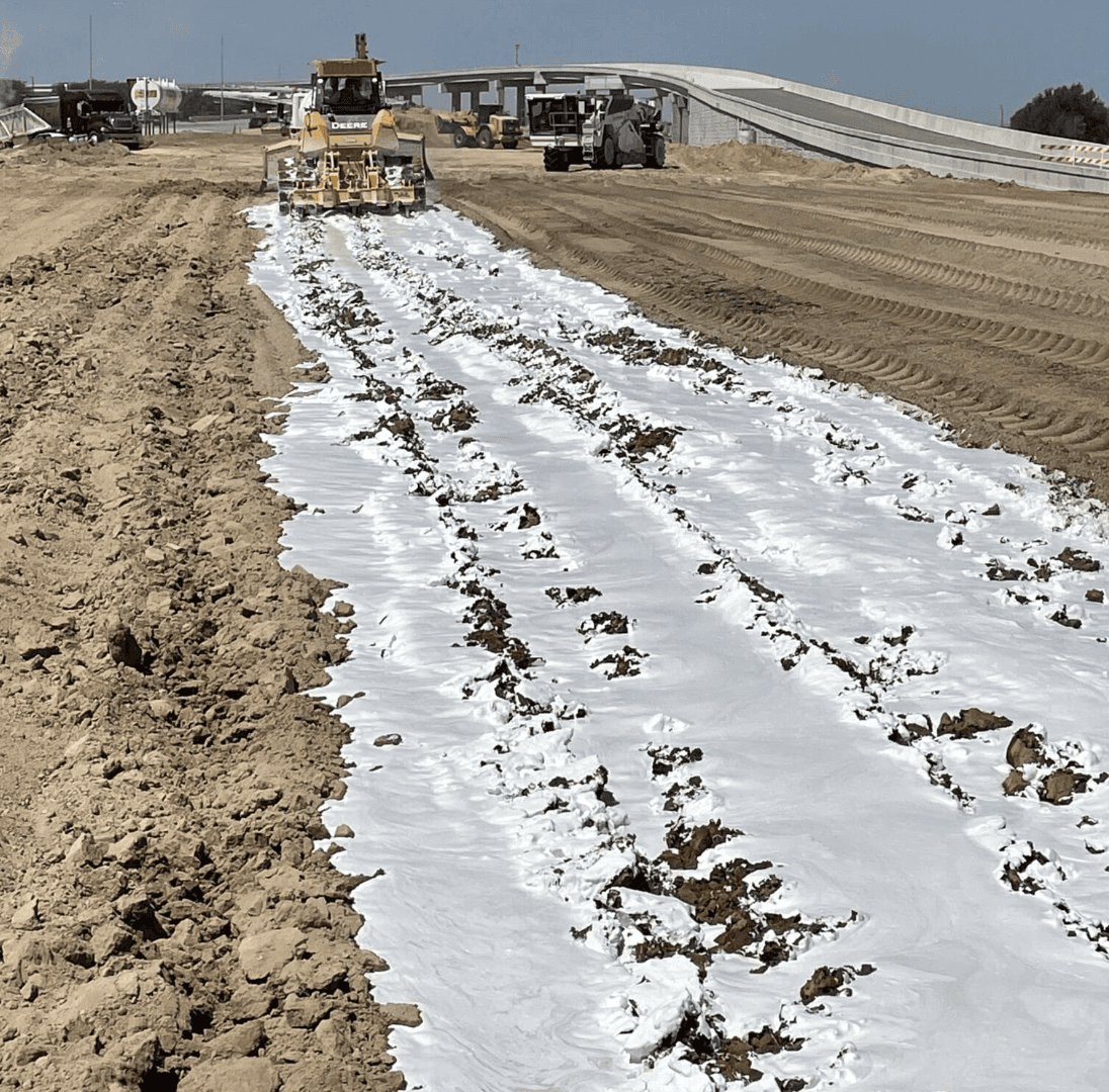 Lime stabilization applied to clay subgrade before compaction.