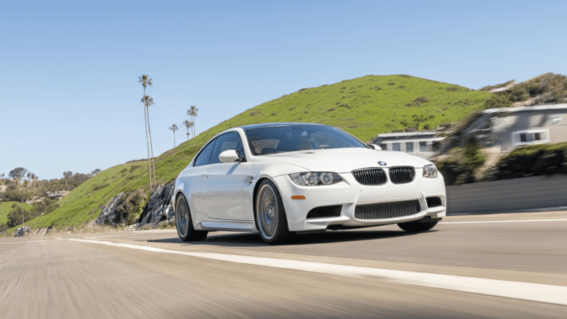 Alpine White BMW E92 M3 enthusiast sports car on California hills road at sunset – documented maintenance boosts resale premium