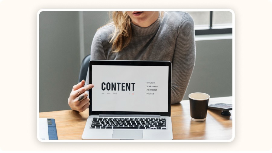 Woman presenting laptop screen displaying content strategy and accessibility keywords indoors