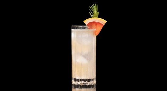 A closeup of a Halston drink against a dark background.