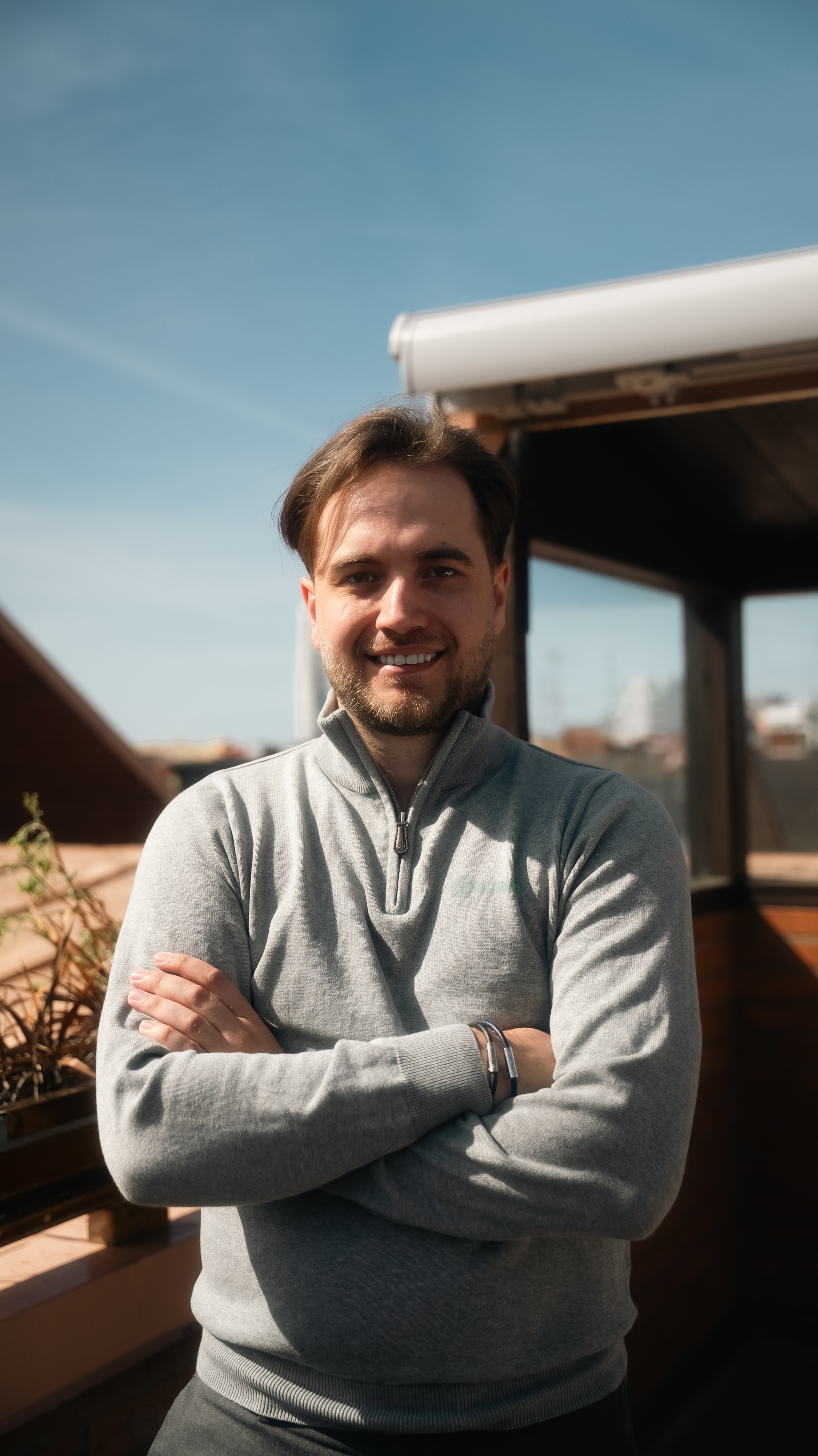Profile portrait of a man in a white shirt against a light background