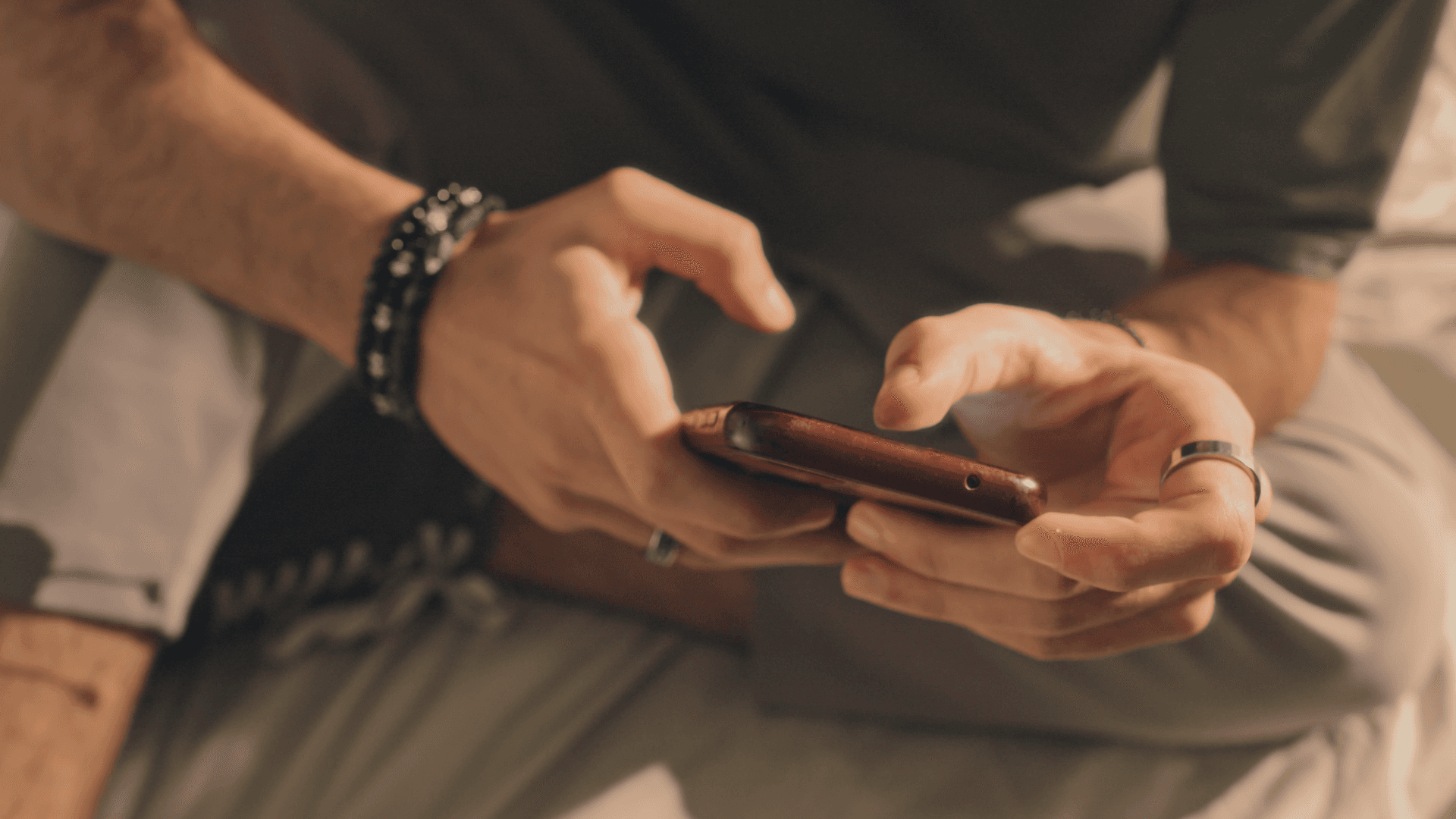 Man typing on a phone.