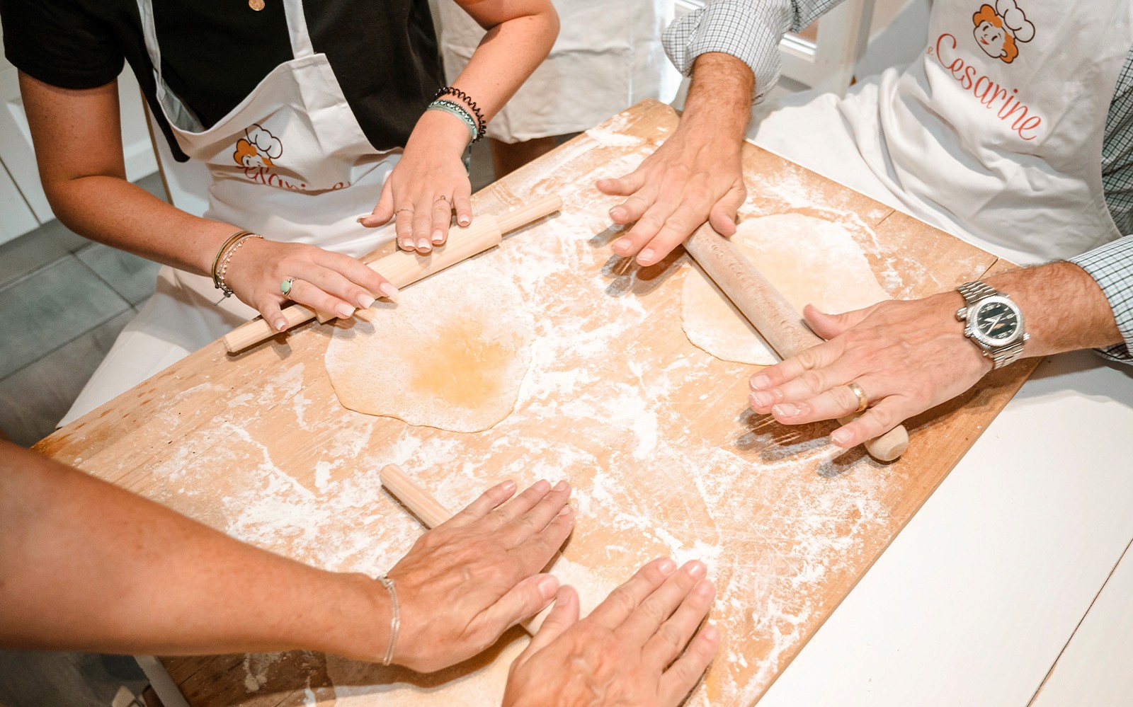 Participants rolling dough in a private cooking class in Milan.