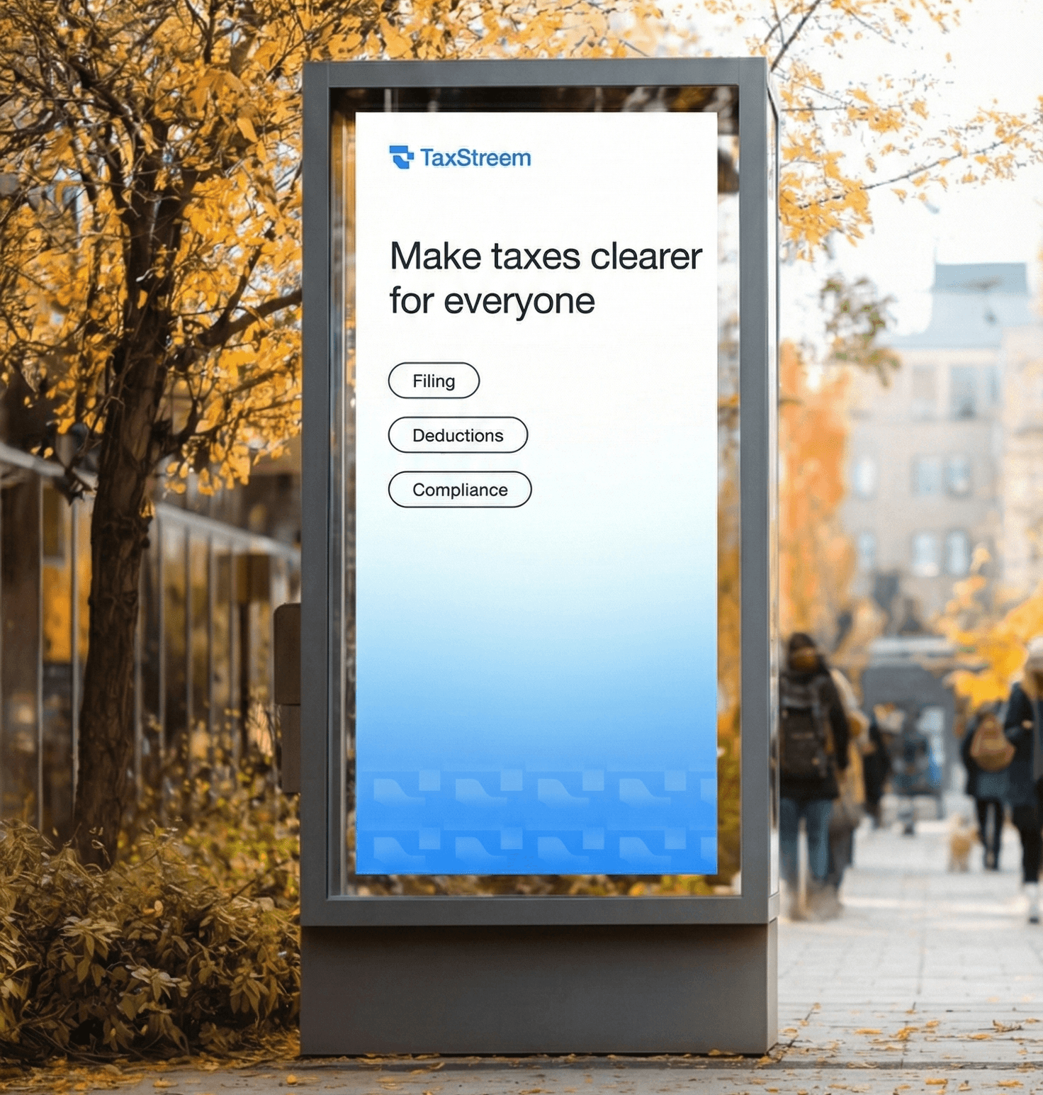 A young person with curly hair smiles at the camera while sitting in front of a laptop against a dark background.