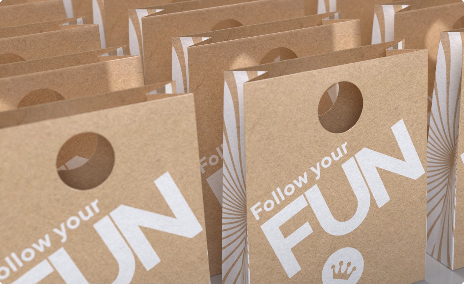Kraft paper bags branded with Follow your fun art