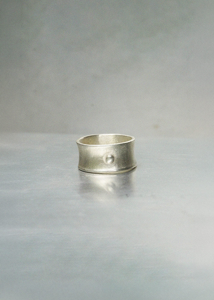 Silver ring on a gray background