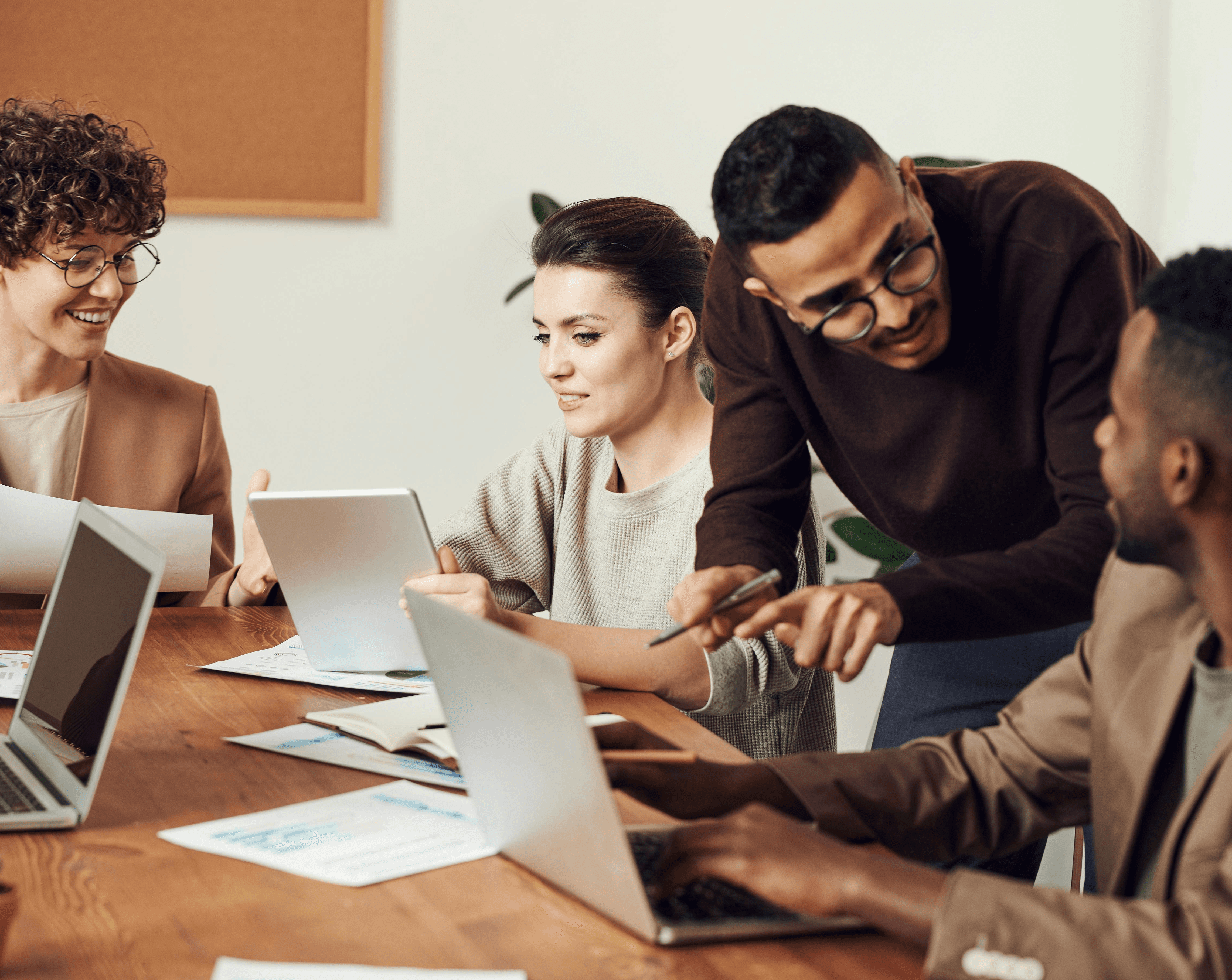 A desk with a laptop and an employee badge laying on top of it.
