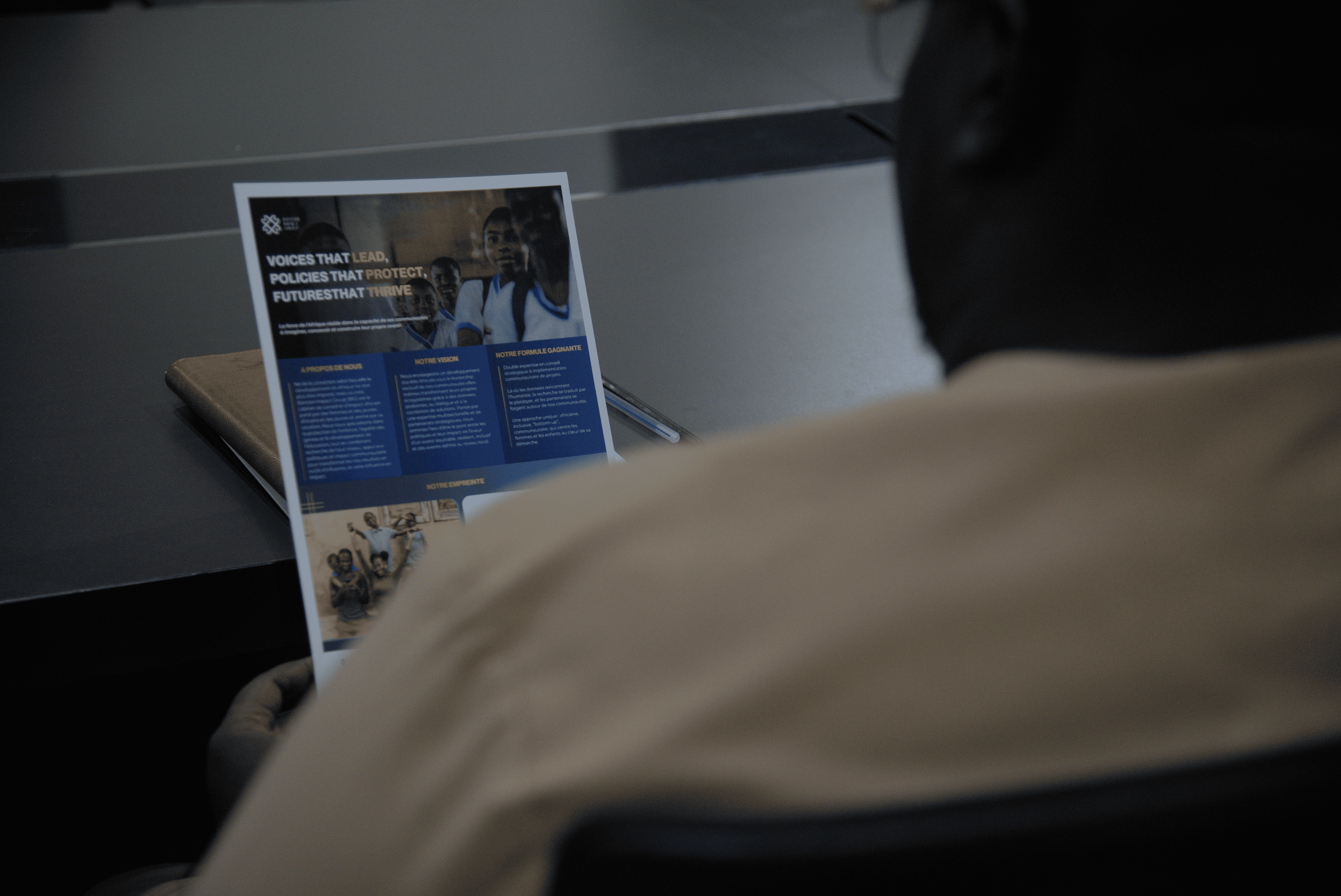 group of women in red and white dress standing on brown wooden bar during daytime