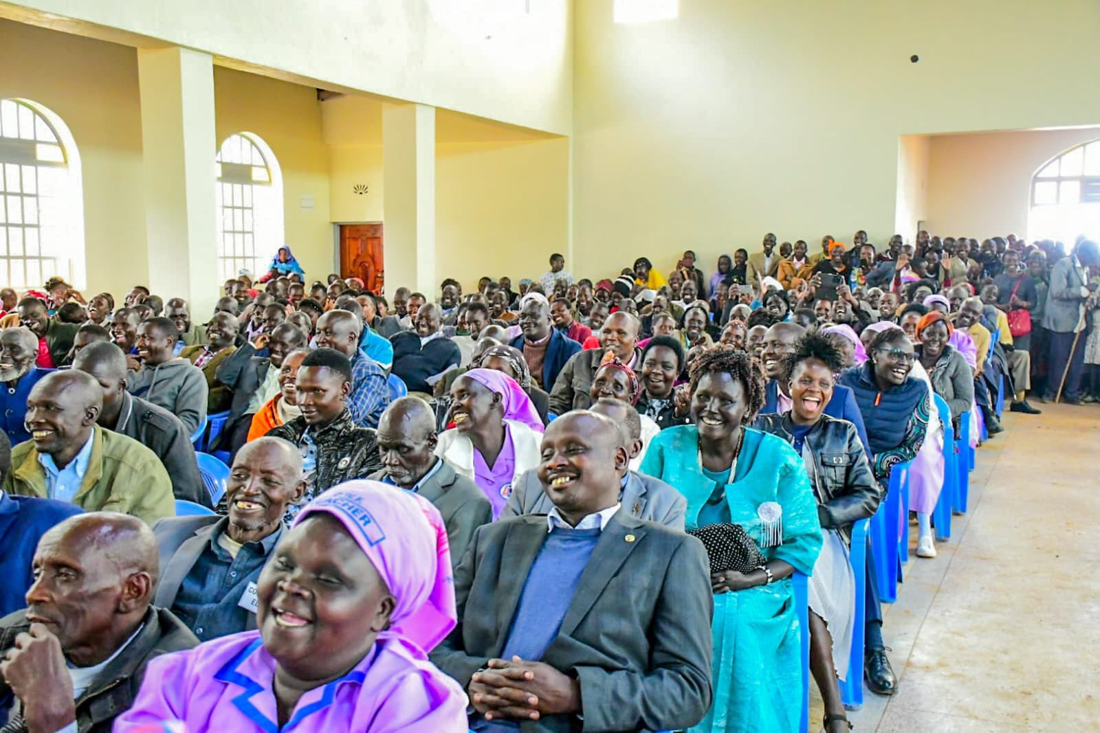Constituents seated and listening at a campaign meeting